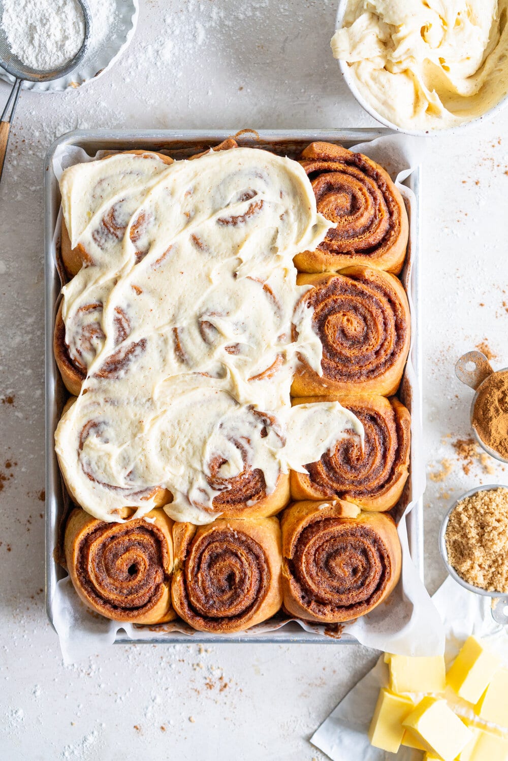 Brown Butter Cinnamon Rolls with Brown Butter Cream Cheese Frosting. Fluffy Brioche is filled with a spiced brown sugar and brown butter cinnamon filing, then rolled up and formed into perfect rolls. The rolls are then baked to perfection, and slathered in a brown butter cream cheese frosting, loaded up with specks of vanilla bean and brown butter. These are the perfect take on a cinnamon roll - the extra effort is well worth it! #brownbuttercinnamonroll #brownbutter #creamcheesefrosting