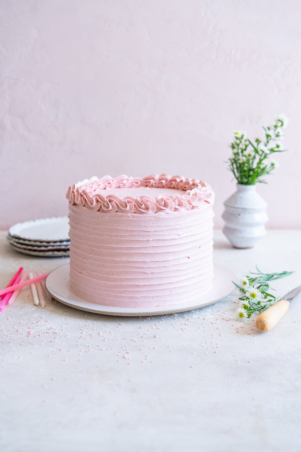 Chocolate Layer Cake with Jam Filling and Strawberry Swiss Meringue Buttercream from Amanda Faber's book, Cake Portfolio. Layers of Rich chocolate cake are layered up with mixed berry jam, and then the cake is finished with a strawberry swiss meringue buttercream made with freeze dried strawberry powder. This is the perfect birthday or celebration cake for anyone who loves strawberry or chocolate. #strawberryswissmeringuebuttercream #chocolatelayercake #layercake