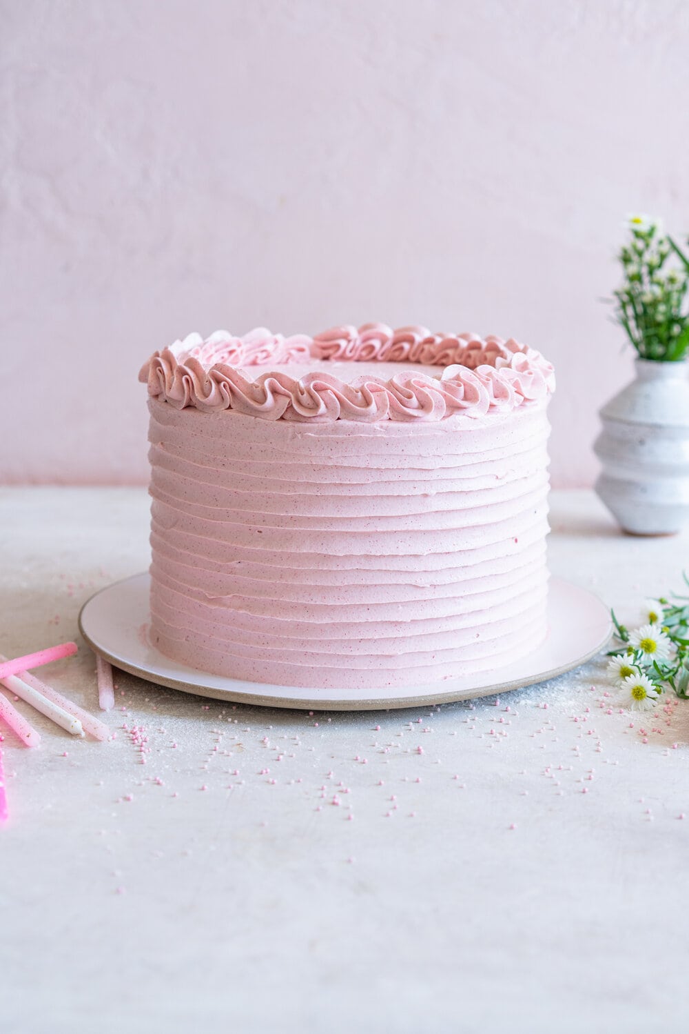 Chocolate Layer Cake with Jam Filling and Strawberry Swiss Meringue Buttercream from Amanda Faber's book, Cake Portfolio. Layers of Rich chocolate cake are layered up with mixed berry jam, and then the cake is finished with a strawberry swiss meringue buttercream made with freeze dried strawberry powder. This is the perfect birthday or celebration cake for anyone who loves strawberry or chocolate. #strawberryswissmeringuebuttercream #chocolatelayercake #layercake