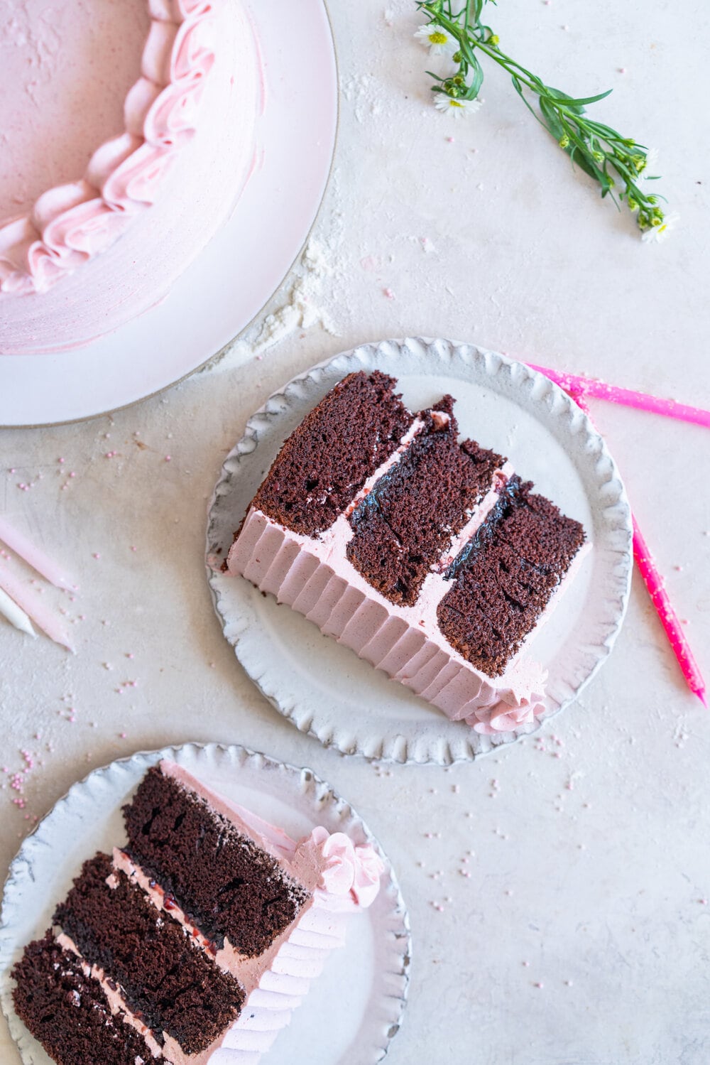 Chocolate Layer Cake with Jam Filling and Strawberry Swiss Meringue Buttercream from Amanda Faber's book, Cake Portfolio. Layers of Rich chocolate cake are layered up with mixed berry jam, and then the cake is finished with a strawberry swiss meringue buttercream made with freeze dried strawberry powder. This is the perfect birthday or celebration cake for anyone who loves strawberry or chocolate. #strawberryswissmeringuebuttercream #chocolatelayercake #layercake