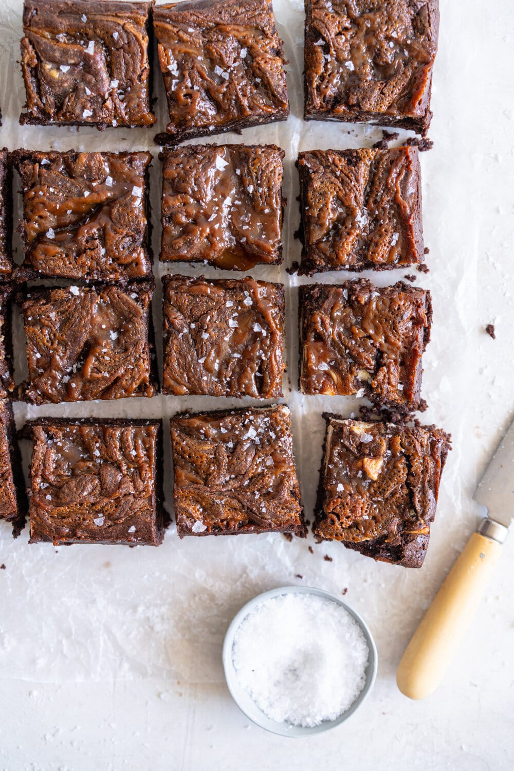 Peanut Butter Caramel Cream Cheese Swirl Brownies - fudgy brownies are swirled with a cheesecake cream cheese layer and then topped with a peanut butter caramel before being baked until fudgy and perfect. These are a must for any cheesecake or peanut butter lovers. #peanutbutterbrownies #creamcheesebrownies #cheesecakebrownies