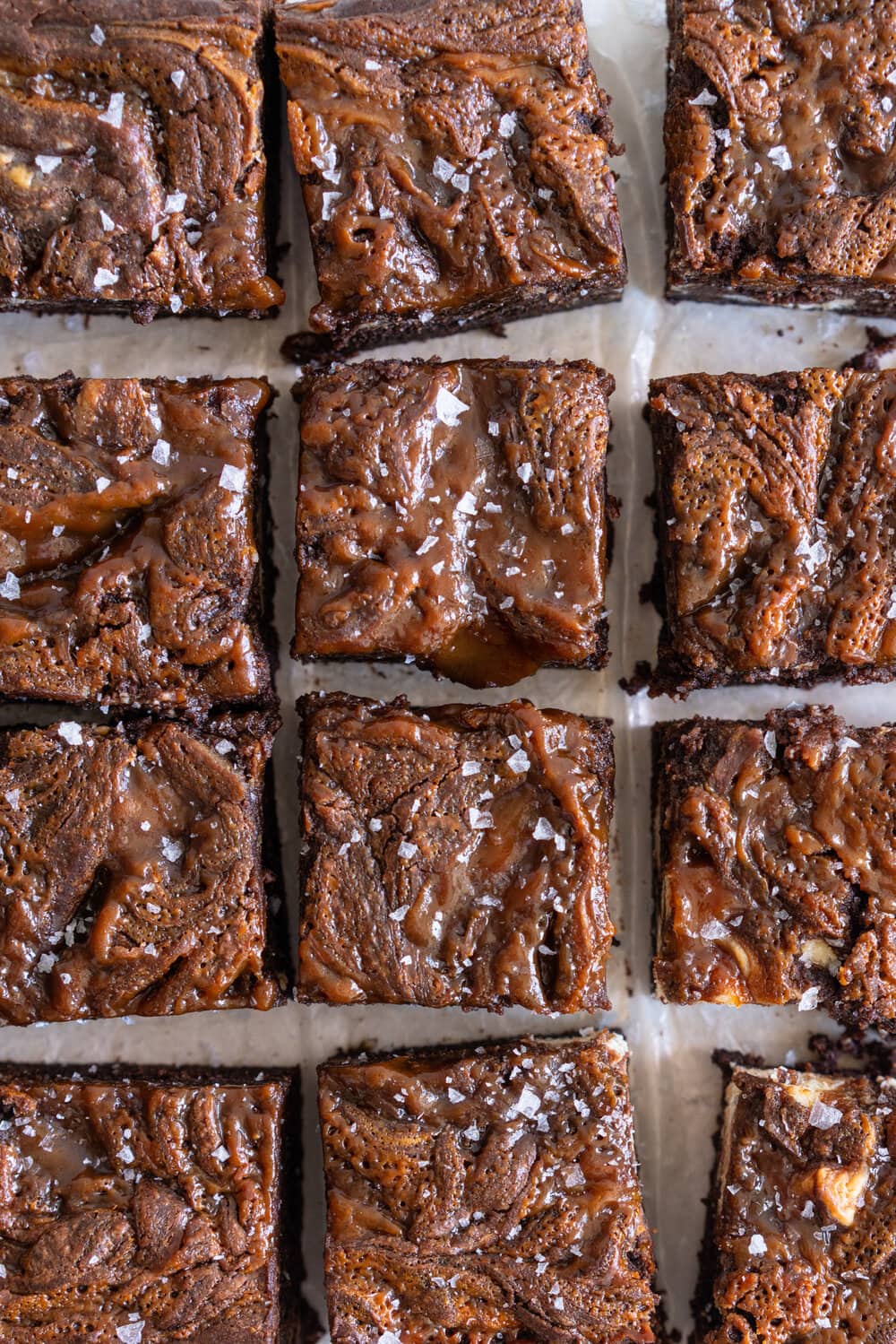 Peanut Butter Caramel Cream Cheese Swirl Brownies - fudgy brownies are swirled with a cheesecake cream cheese layer and then topped with a peanut butter caramel before being baked until fudgy and perfect. These are a must for any cheesecake or peanut butter lovers. #peanutbutterbrownies #creamcheesebrownies #cheesecakebrownies