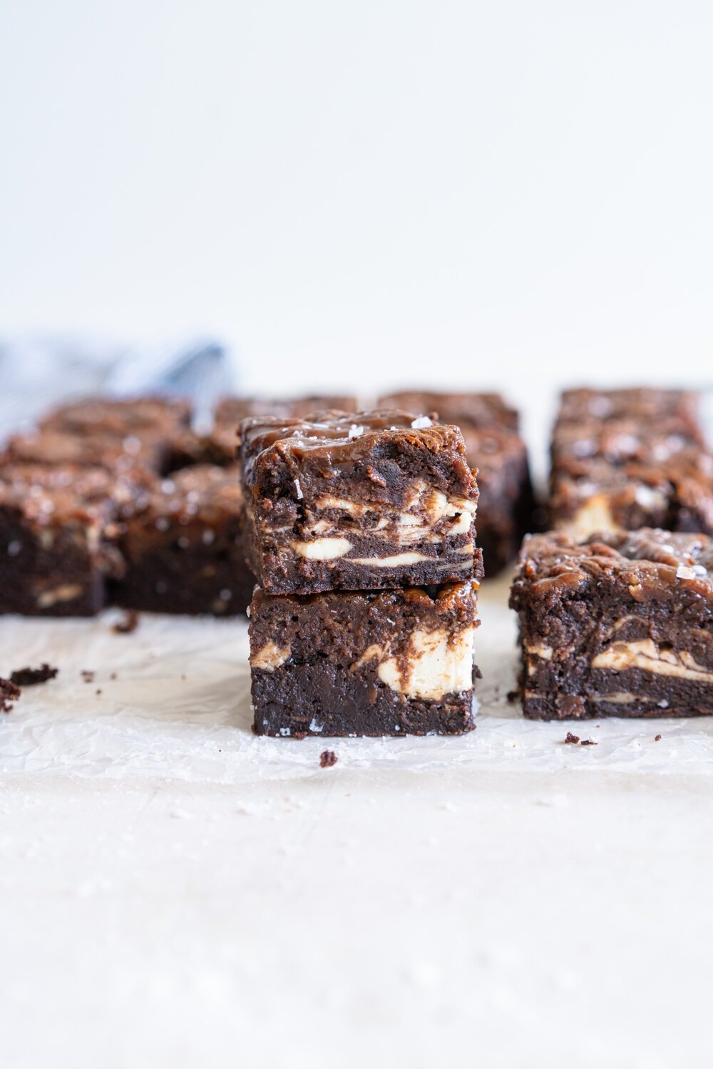Peanut Butter Caramel Cream Cheese Swirl Brownies - fudgy brownies are swirled with a cheesecake cream cheese layer and then topped with a peanut butter caramel before being baked until fudgy and perfect. These are a must for any cheesecake or peanut butter lovers. #peanutbutterbrownies #creamcheesebrownies #cheesecakebrownies