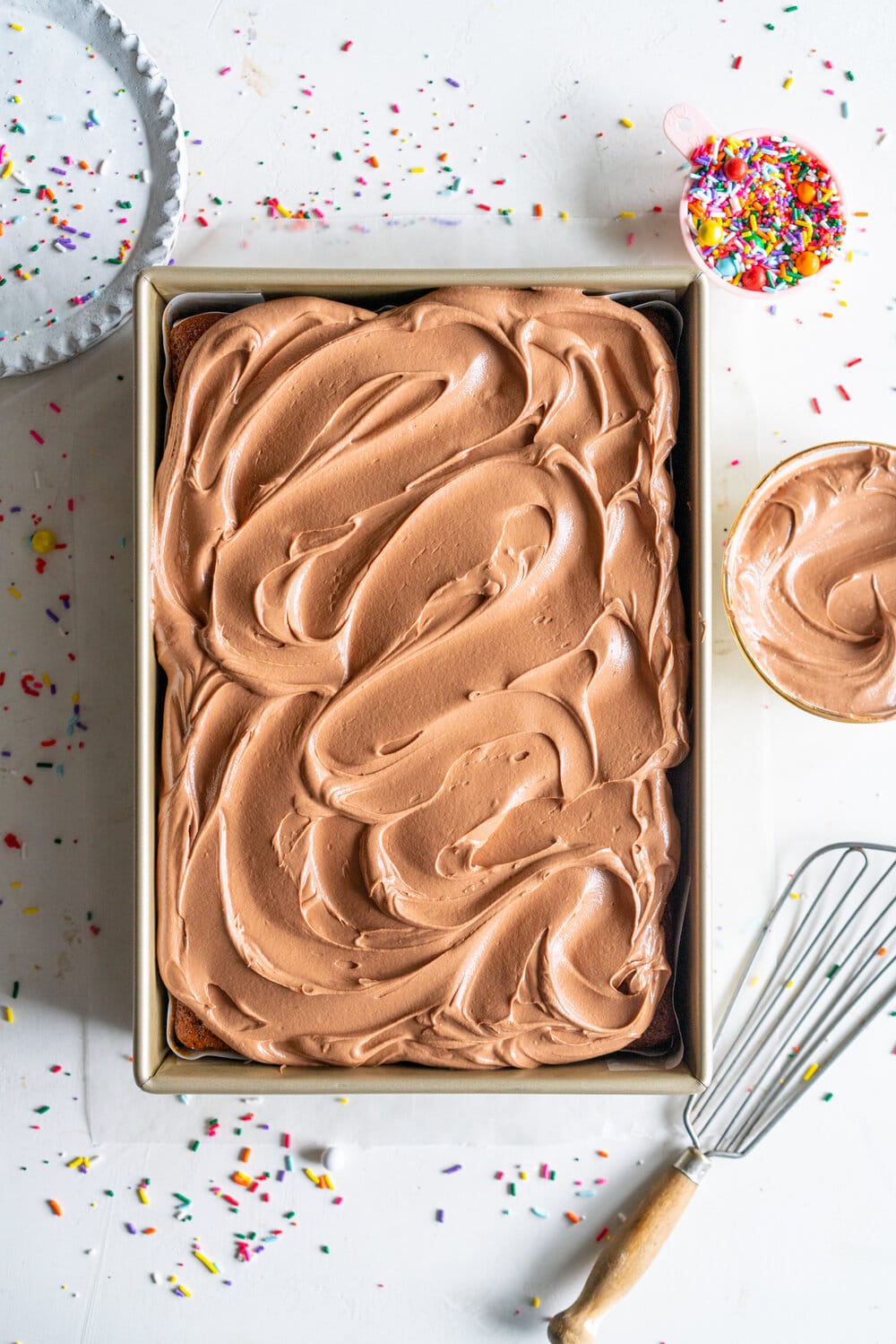 Tahini Brown Sugar Sheet Cake with Chocolate Fudge Frosting. A perfectly moist stir together sheet cake, with brown sugar and tahini, is topped with a simple chocolate fudge frosting that comes together quickly in the food processor. This recipe is from Michelle Lopez's latest book, Weeknight baking. #sheetcake #tahinicake