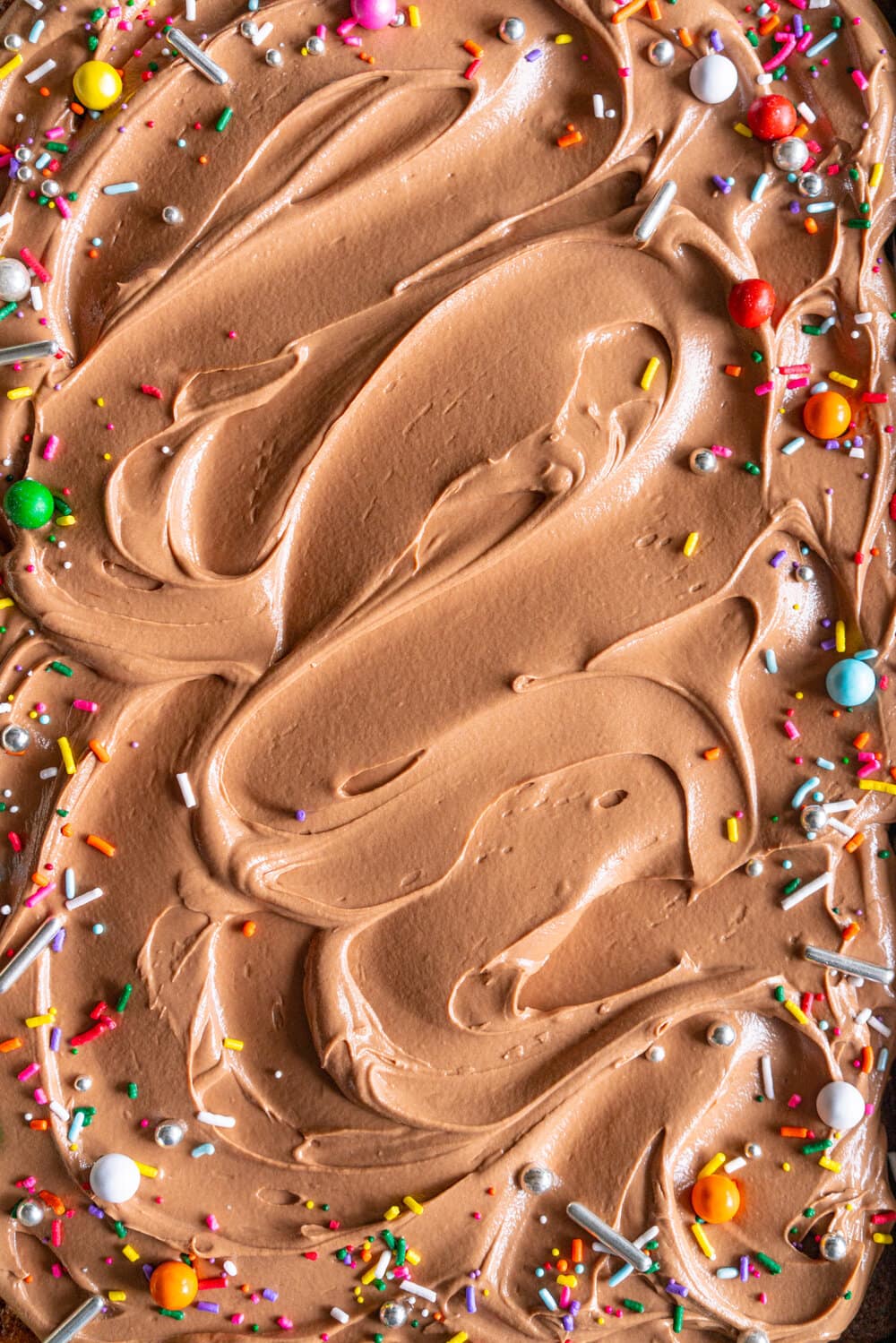 Tahini Brown Sugar Sheet Cake with Chocolate Fudge Frosting. A perfectly moist stir together sheet cake, with brown sugar and tahini, is topped with a simple chocolate fudge frosting that comes together quickly in the food processor. This recipe is from Michelle Lopez's latest book, Weeknight baking. #sheetcake #tahinicake