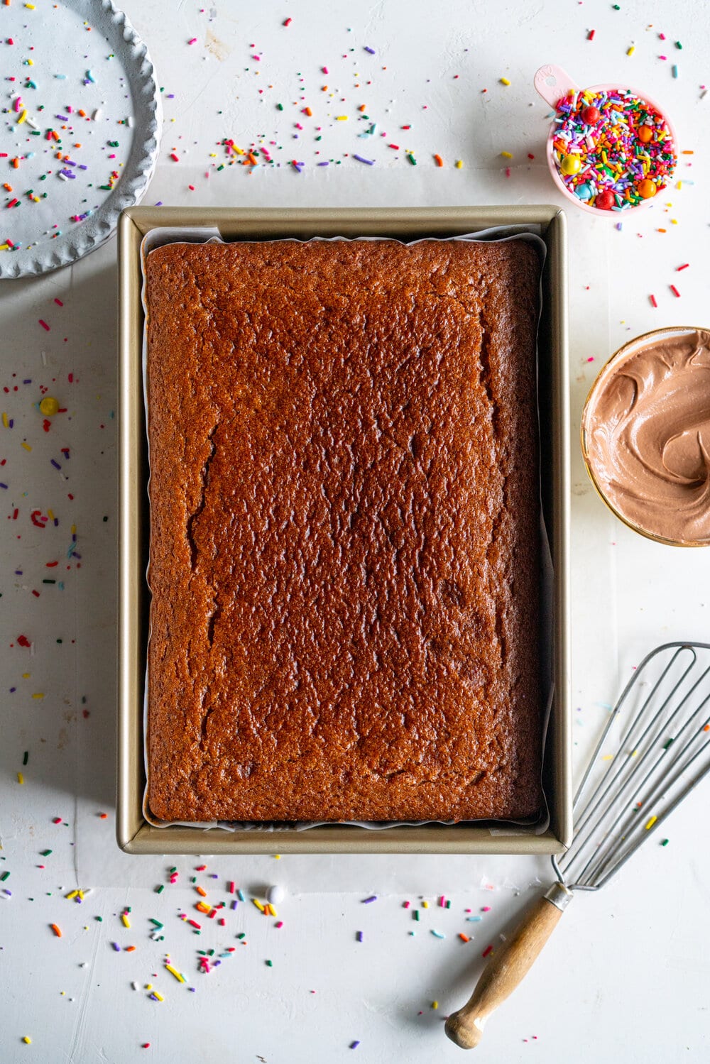 Tahini Brown Sugar Sheet Cake with Chocolate Fudge Frosting. A perfectly moist stir together sheet cake, with brown sugar and tahini, is topped with a simple chocolate fudge frosting that comes together quickly in the food processor. This recipe is from Michelle Lopez's latest book, Weeknight baking. #sheetcake #tahinicake