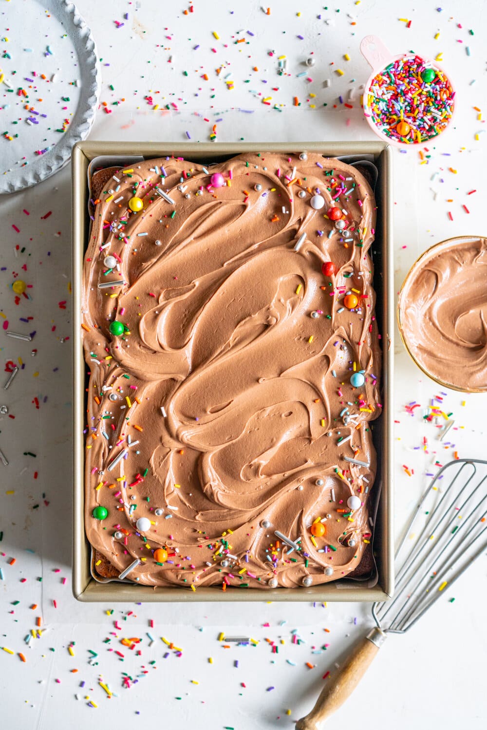 Tahini Brown Sugar Sheet Cake with Chocolate Fudge Frosting. A perfectly moist stir together sheet cake, with brown sugar and tahini, is topped with a simple chocolate fudge frosting that comes together quickly in the food processor. This recipe is from Michelle Lopez's latest book, Weeknight baking. #sheetcake #tahinicake