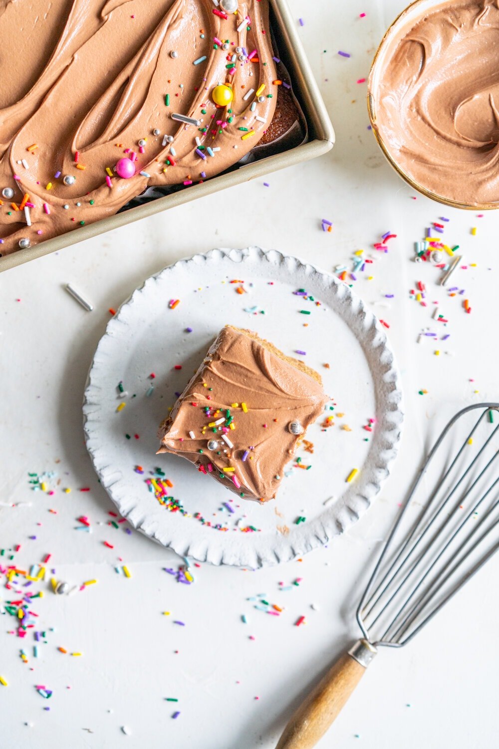 Tahini Brown Sugar Sheet Cake with Chocolate Fudge Frosting. A perfectly moist stir together sheet cake, with brown sugar and tahini, is topped with a simple chocolate fudge frosting that comes together quickly in the food processor. This recipe is from Michelle Lopez's latest book, Weeknight baking. #sheetcake #tahinicake