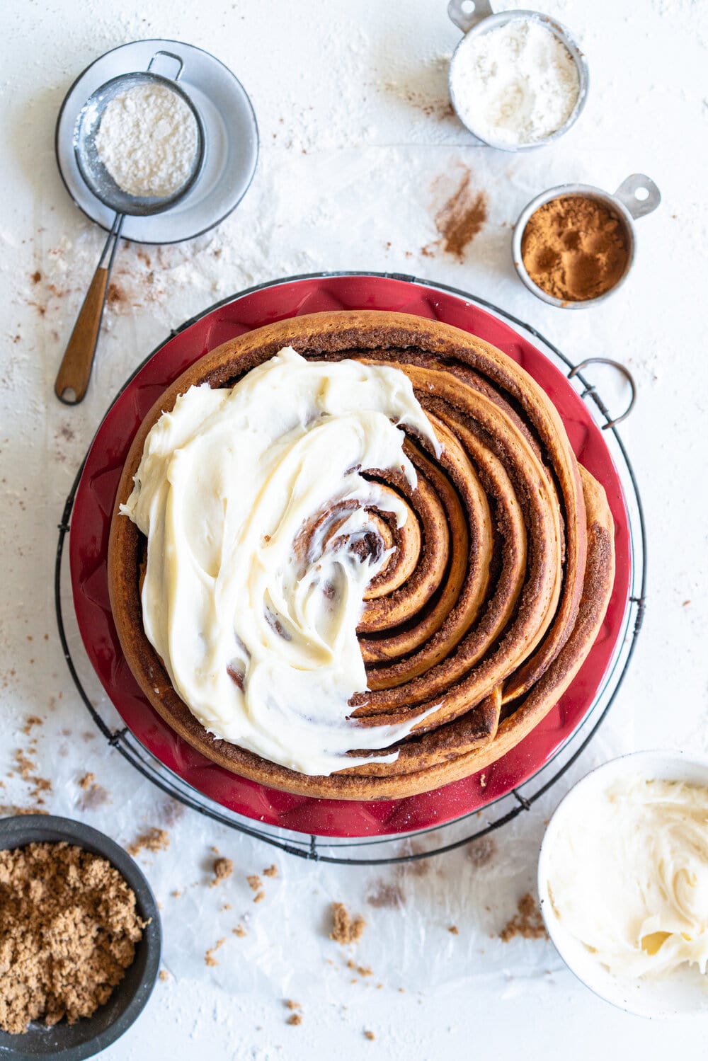 Giant Sour Cream Brioche Cinnamon Roll with Cream Cheese Frosting. A huge cinnamon roll, made from soft, pillowy brioche enriched with sour cream, is spread with a cinnamon sugar mixture and rolled up into a giant cinnamon roll which is baked until perfect and fluffy. It is then finished with a simple cream cheese frosting. This is the perfect holiday breakfast or brunch treat! #giantcinnamonroll #sourcreambrioche #creamcheesefrosting