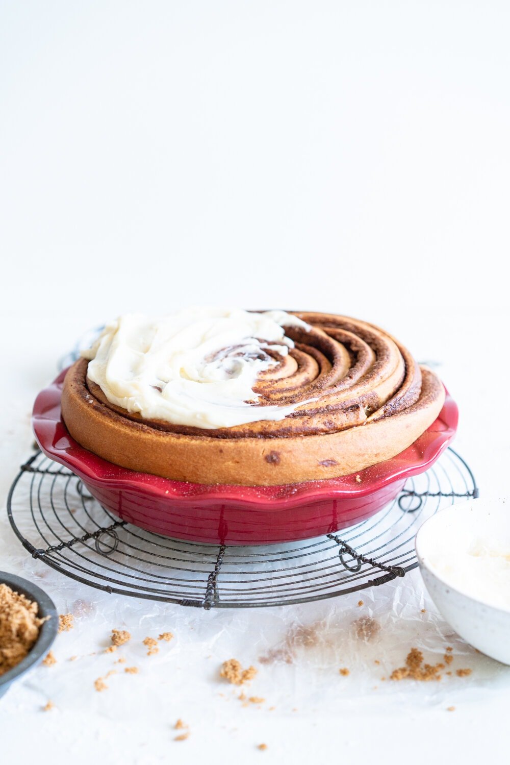 Giant Sour Cream Brioche Cinnamon Roll with Cream Cheese Frosting. A huge cinnamon roll, made from soft, pillowy brioche enriched with sour cream, is spread with a cinnamon sugar mixture and rolled up into a giant cinnamon roll which is baked until perfect and fluffy. It is then finished with a simple cream cheese frosting. This is the perfect holiday breakfast or brunch treat! #giantcinnamonroll #sourcreambrioche #creamcheesefrosting
