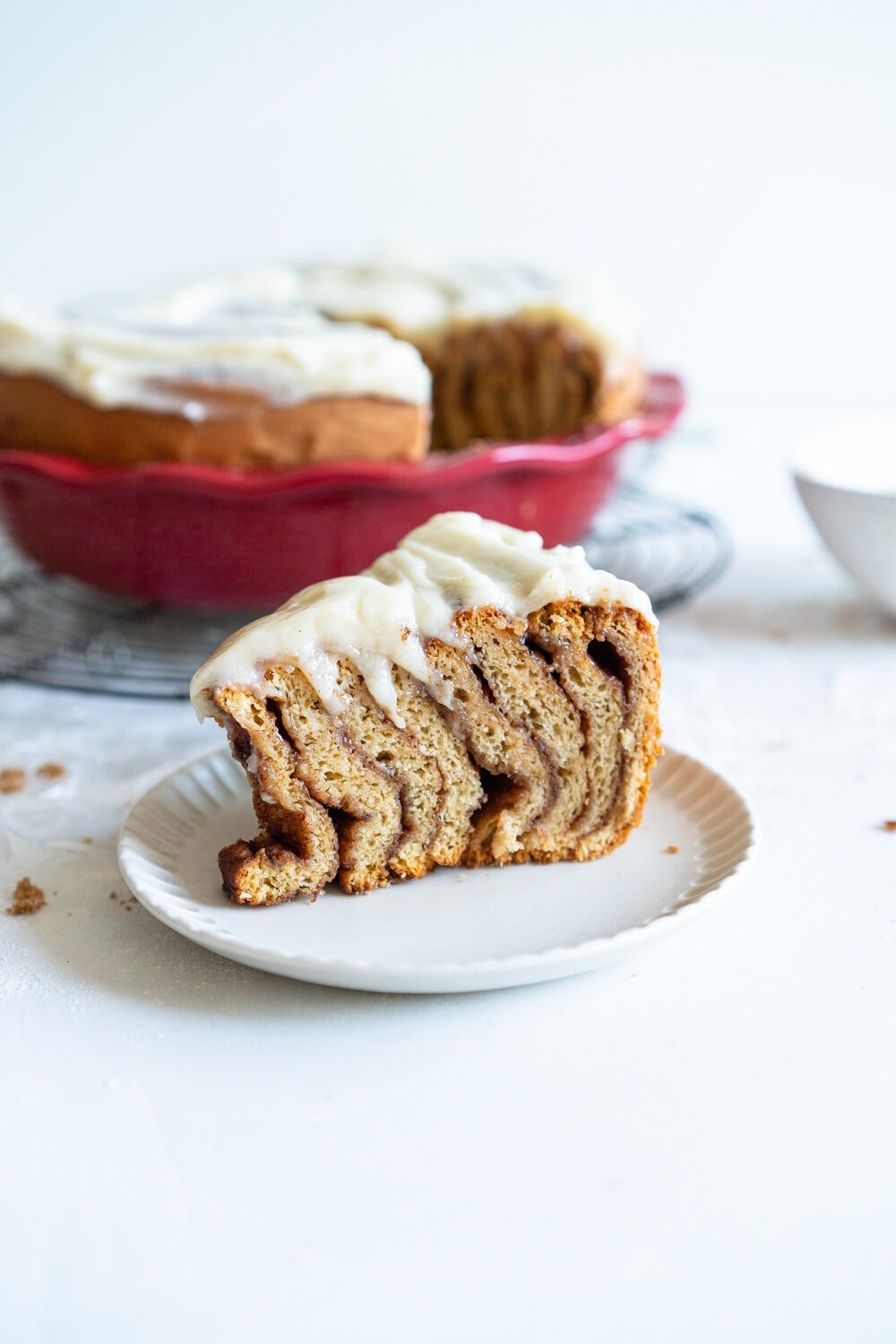 Giant Sour Cream Brioche Cinnamon Roll with Cream Cheese Frosting. A huge cinnamon roll, made from soft, pillowy brioche enriched with sour cream, is spread with a cinnamon sugar mixture and rolled up into a giant cinnamon roll which is baked until perfect and fluffy. It is then finished with a simple cream cheese frosting. This is the perfect holiday breakfast or brunch treat! #giantcinnamonroll #sourcreambrioche #creamcheesefrosting