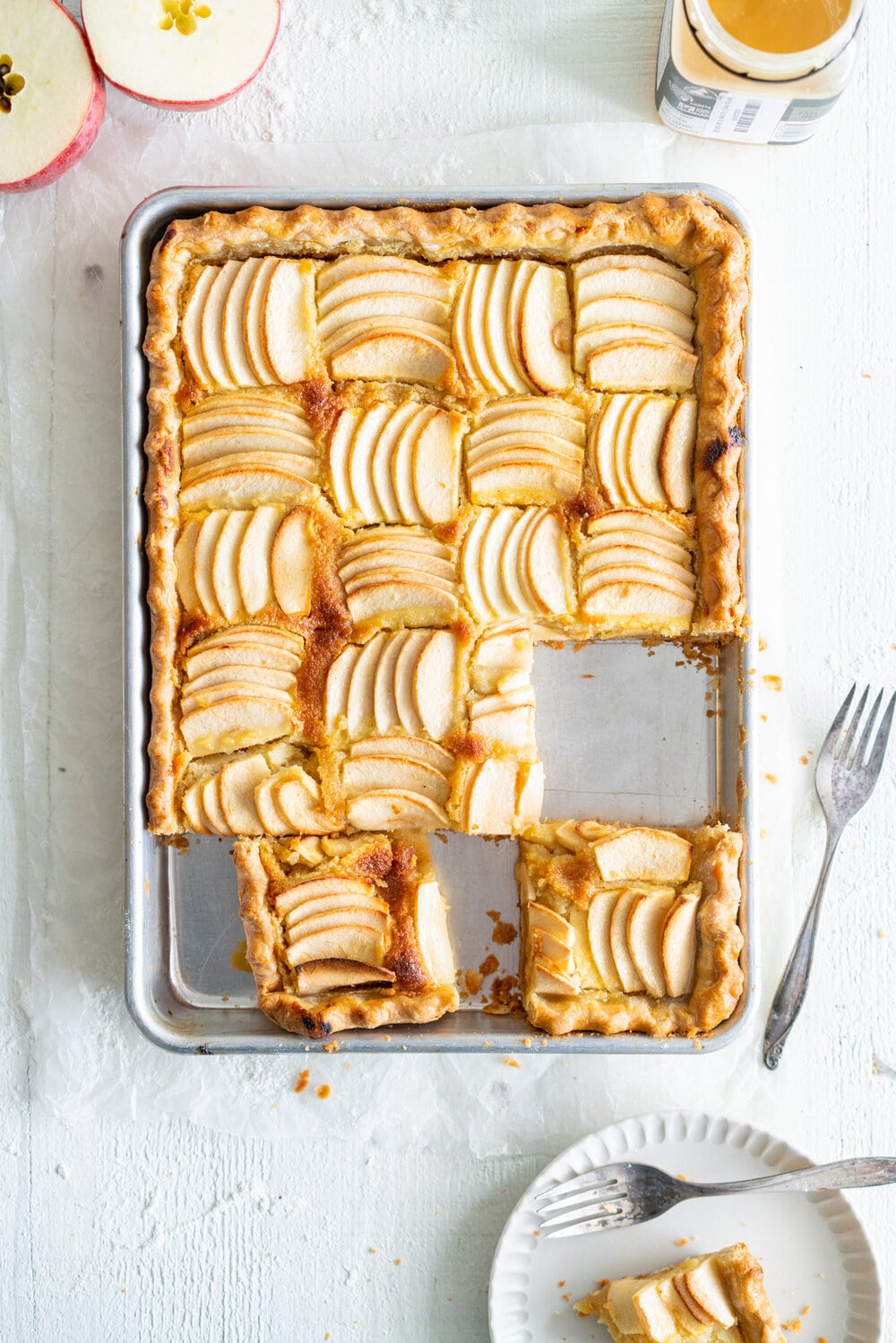 Open Apple Slab Pie with Honey Vanilla Bean Frangipane. Crispy, flaky pie dough is topped with a honey and vanilla bean frangipane mixture, covered with sliced apples, and baked to golden perfection. This is the perfect alternative to an apple pie for this holiday season. #appletart #applepie #frangipane #honeyfrangipane