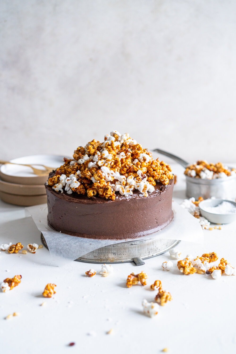 Chocolate Buttermilk Cake with Chocolate Cream Cheese Frosting and Honey Caramel Corn. A one bowl chocolate cake is finished with a chocolate cream cheese icing and topped with honey caramel corn. This cake is easy to make, only takes one bowl, and is perfectly moist from the addition of the buttermilk. It comes from Charlotte Ree's new book, 'Just Desserts'  #chocolatecake #chocolatebuttermilkcake #caramelcorn