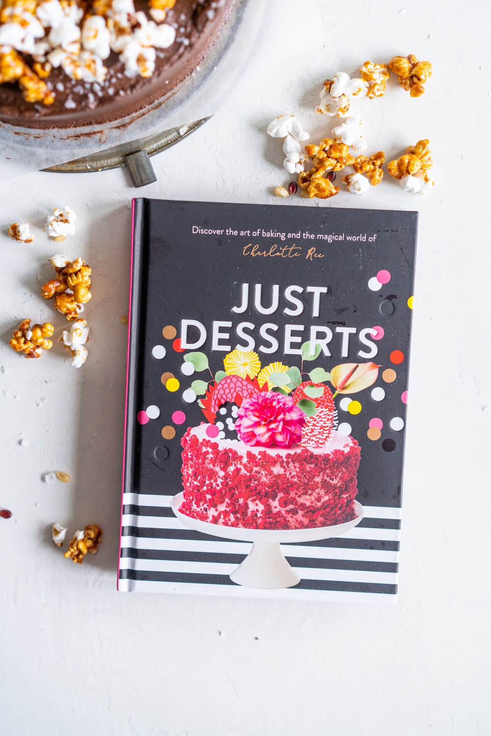 Chocolate Buttermilk Cake with Chocolate Cream Cheese Frosting and Honey Caramel Corn. A one bowl chocolate cake is finished with a chocolate cream cheese icing and topped with honey caramel corn. This cake is easy to make, only takes one bowl, and is perfectly moist from the addition of the buttermilk. It comes from Charlotte Ree's new book, 'Just Desserts'  #chocolatecake #chocolatebuttermilkcake #caramelcorn