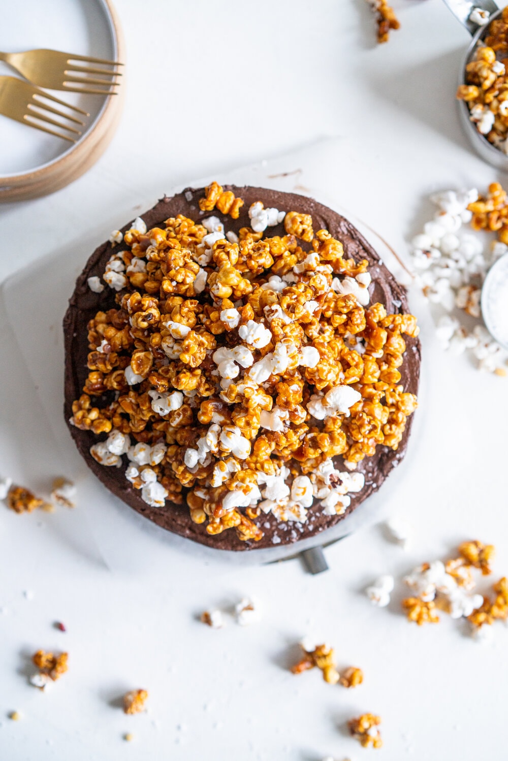 Chocolate Buttermilk Cake with Chocolate Cream Cheese Frosting and Honey Caramel Corn. A one bowl chocolate cake is finished with a chocolate cream cheese icing and topped with honey caramel corn. This cake is easy to make, only takes one bowl, and is perfectly moist from the addition of the buttermilk. It comes from Charlotte Ree's new book, 'Just Desserts'  #chocolatecake #chocolatebuttermilkcake #caramelcorn