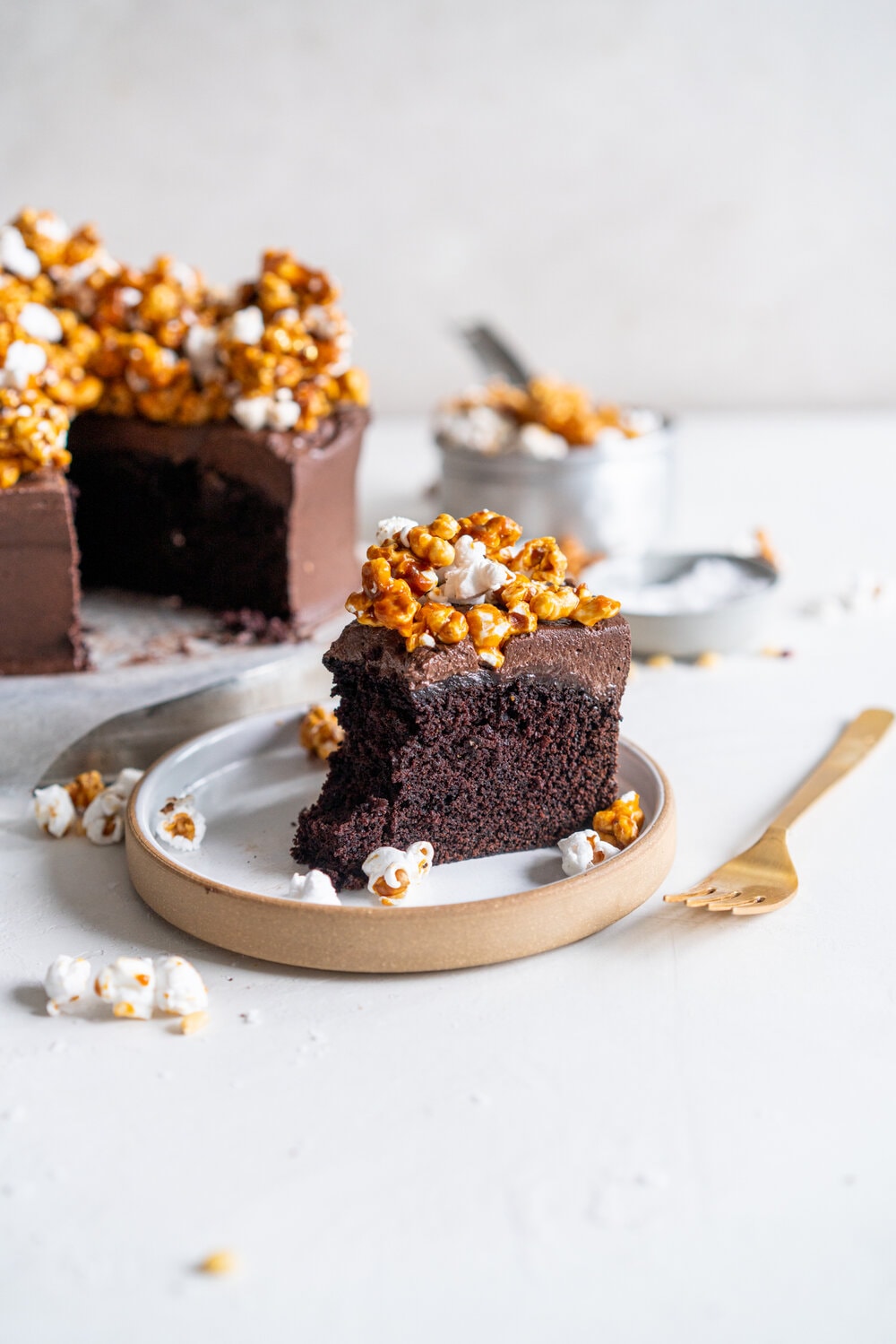 Chocolate Buttermilk Cake with Chocolate Cream Cheese Frosting and Honey Caramel Corn. A one bowl chocolate cake is finished with a chocolate cream cheese icing and topped with honey caramel corn. This cake is easy to make, only takes one bowl, and is perfectly moist from the addition of the buttermilk. It comes from Charlotte Ree's new book, 'Just Desserts'  #chocolatecake #chocolatebuttermilkcake #caramelcorn