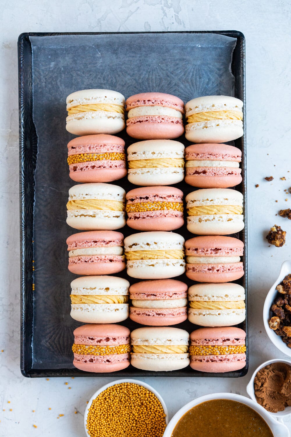 Spiced Pumpkin and Walnut Praline macarons. These are thanksgiving inspired macarons, with a walnut praline swiss meringue buttercream and a spiced pumpkin swiss meringue buttercream, these easy, no-fail french macarons are a perfect addition to your holiday dessert table.