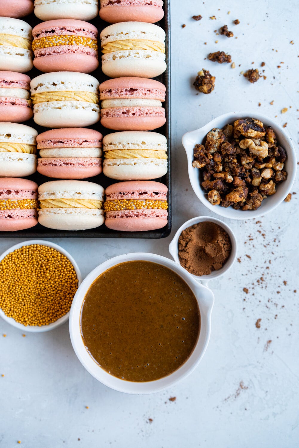 Spiced Pumpkin and Walnut Praline macarons. These are thanksgiving inspired macarons, with a walnut praline swiss meringue buttercream and a spiced pumpkin swiss meringue buttercream, these easy, no-fail french macarons are a perfect addition to your holiday dessert table.