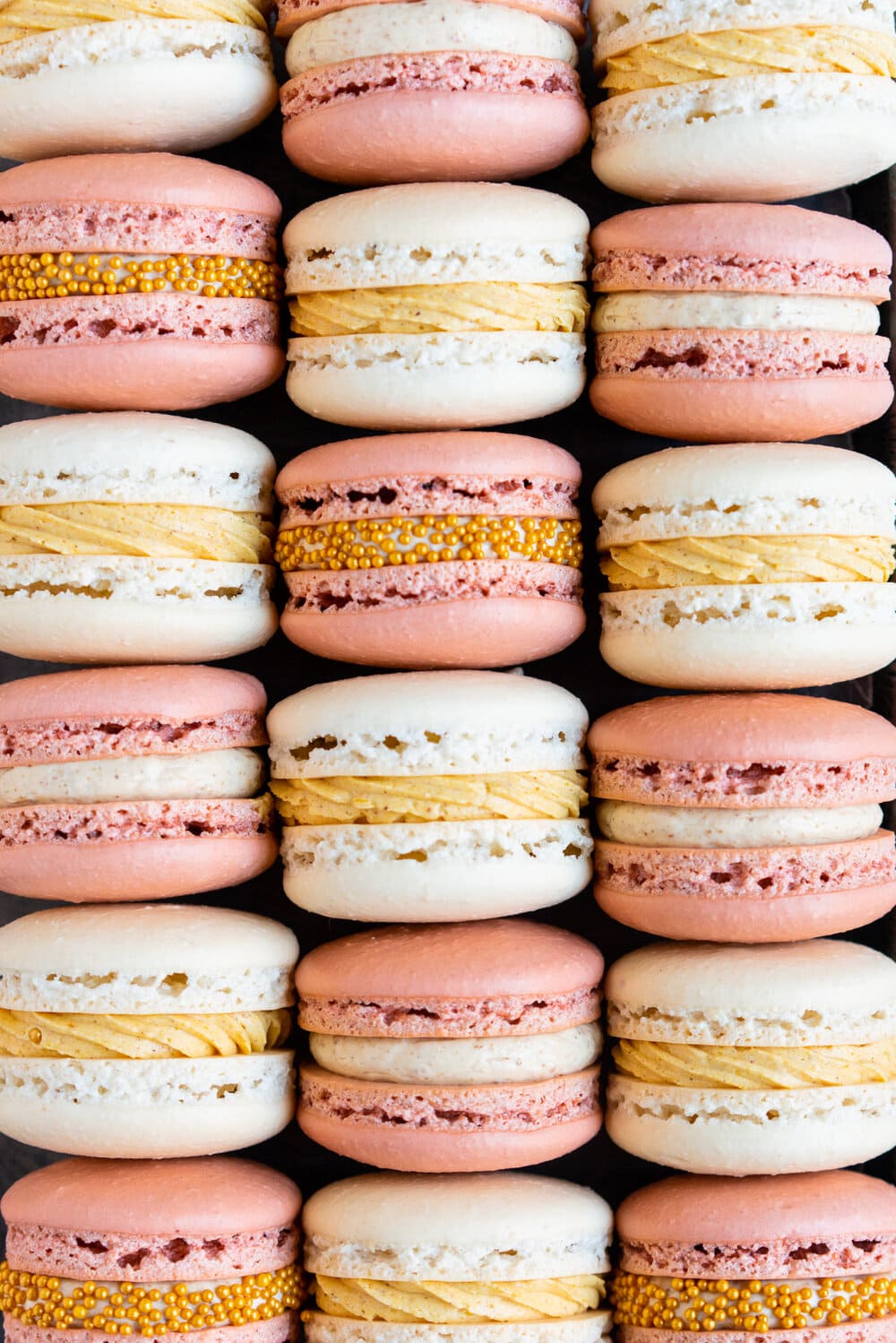 Spiced Pumpkin and Walnut Praline macarons. These are thanksgiving inspired macarons, with a walnut praline swiss meringue buttercream and a spiced pumpkin swiss meringue buttercream, these easy, no-fail french macarons are a perfect addition to your holiday dessert table.