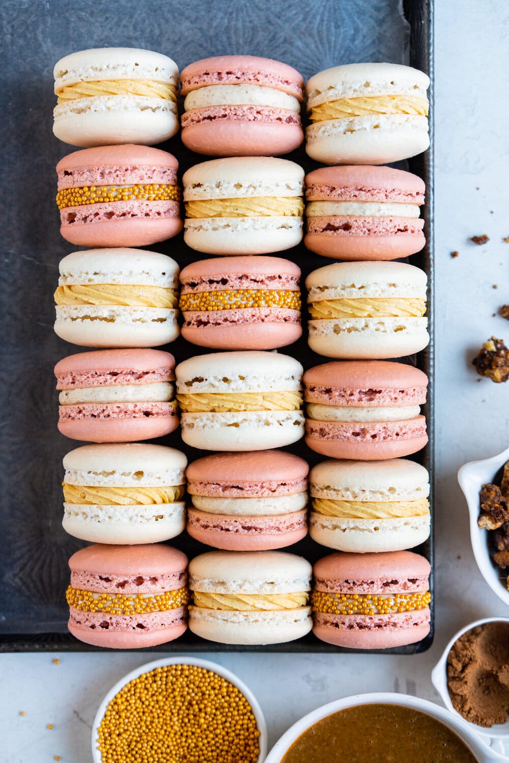 Spiced Pumpkin and Walnut Praline macarons. These are thanksgiving inspired macarons, with a walnut praline swiss meringue buttercream and a spiced pumpkin swiss meringue buttercream, these easy, no-fail french macarons are a perfect addition to your holiday dessert table.