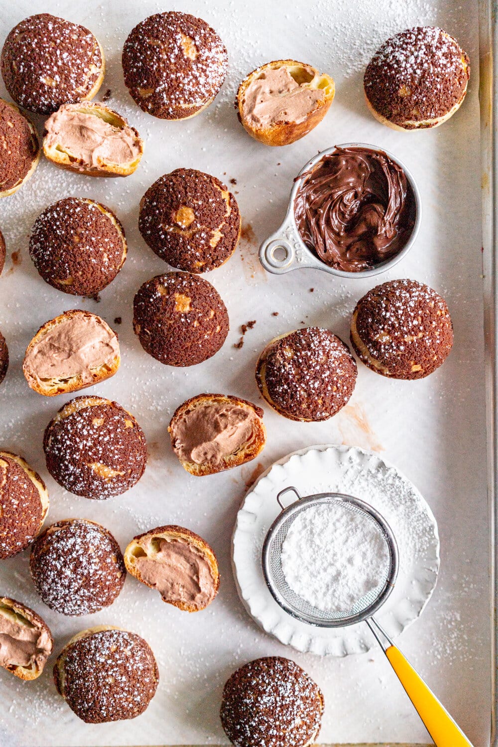 Chocolate Choux au Craquelin with Chocolate Hazelnut Whipped Cream Filling. Rounds of Choux dough are topped with chocolate craquelin and baked to perfection, then filled with silky chocolate hazelnut whipped cream #chouxaucraquelin #creampuffs #chocolatehazelnut