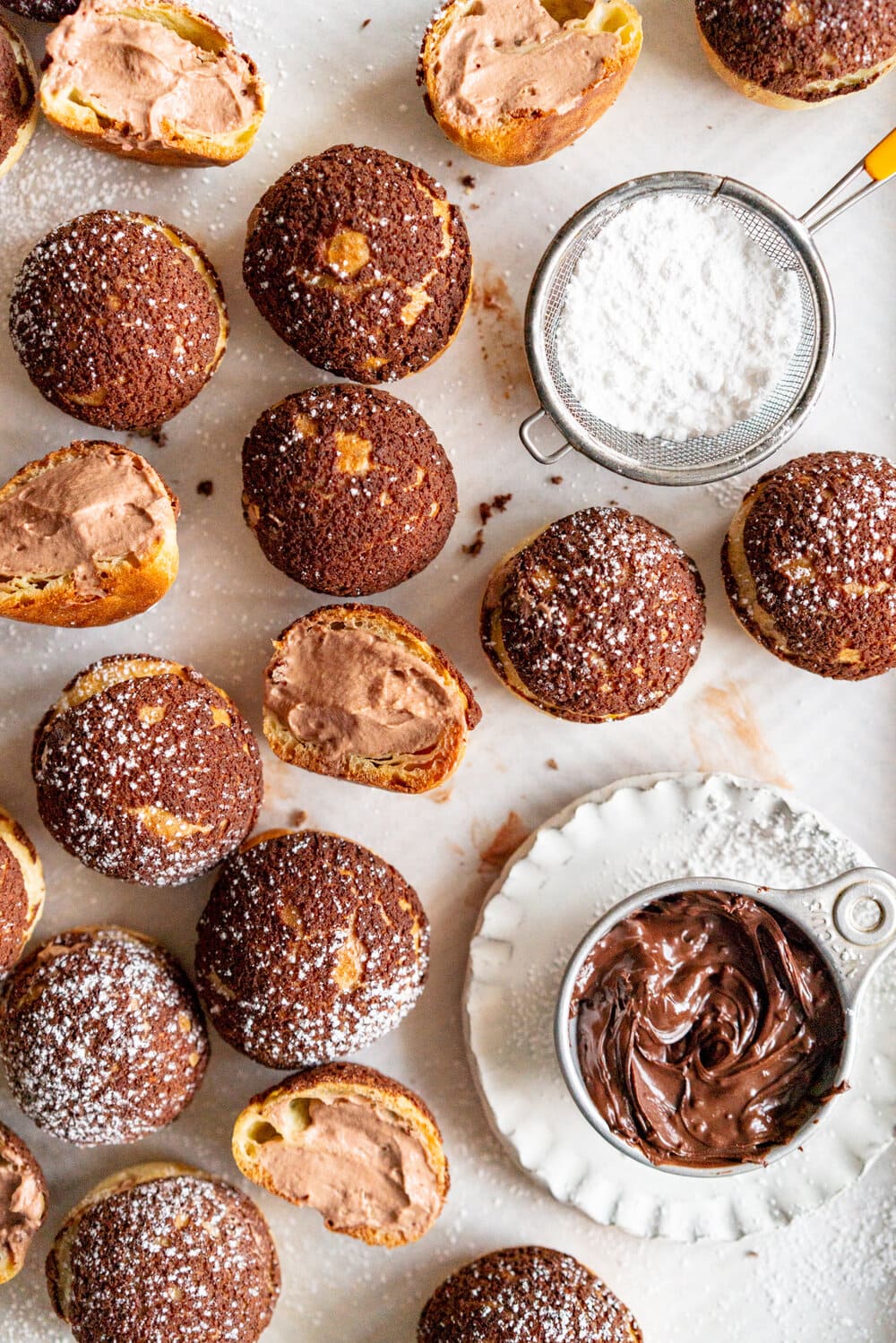 Chocolate Choux au Craquelin with Chocolate Hazelnut Whipped Cream Filling. Rounds of Choux dough are topped with chocolate craquelin and baked to perfection, then filled with silky chocolate hazelnut whipped cream #chouxaucraquelin #creampuffs #chocolatehazelnut
