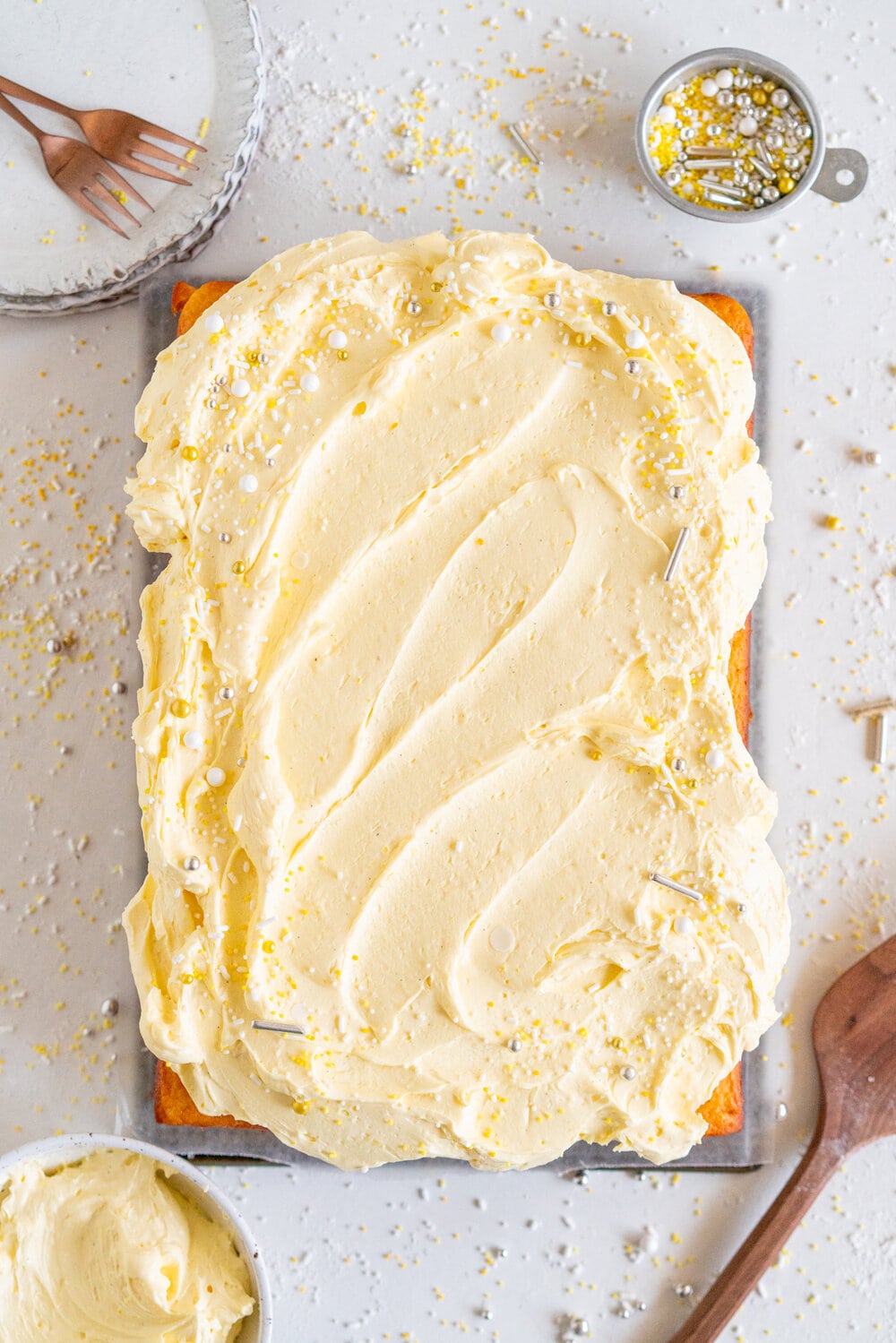 Lemon Yogurt Sheet Cake with Lemon Curd Swiss Meringue Buttercream. Fluffy lemon yogurt cake is topped with a punchy, silky lemon curd swiss meringue buttercream. This sheet cake is perfect for feeding a crowd. #sheetcake #lemoncurd #swissmeringuebuttercream