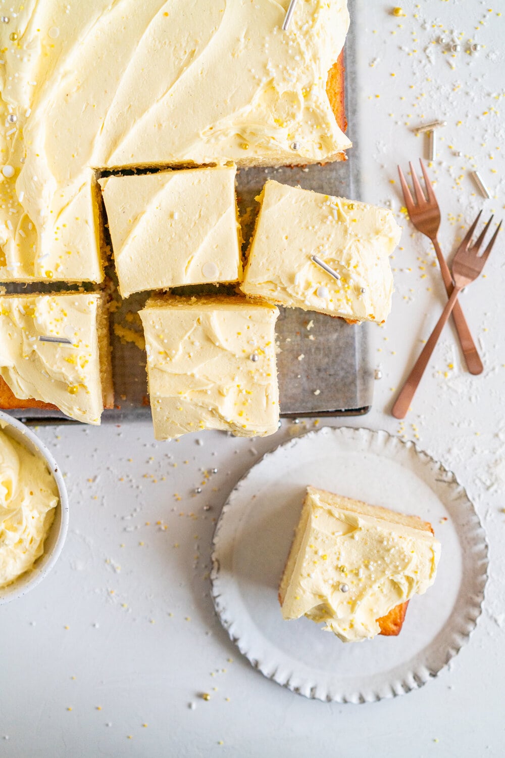 Lemon Yogurt Sheet Cake with Lemon Curd Swiss Meringue Buttercream. Fluffy lemon yogurt cake is topped with a punchy, silky lemon curd swiss meringue buttercream. This sheet cake is perfect for feeding a crowd. #sheetcake #lemoncurd #swissmeringuebuttercream