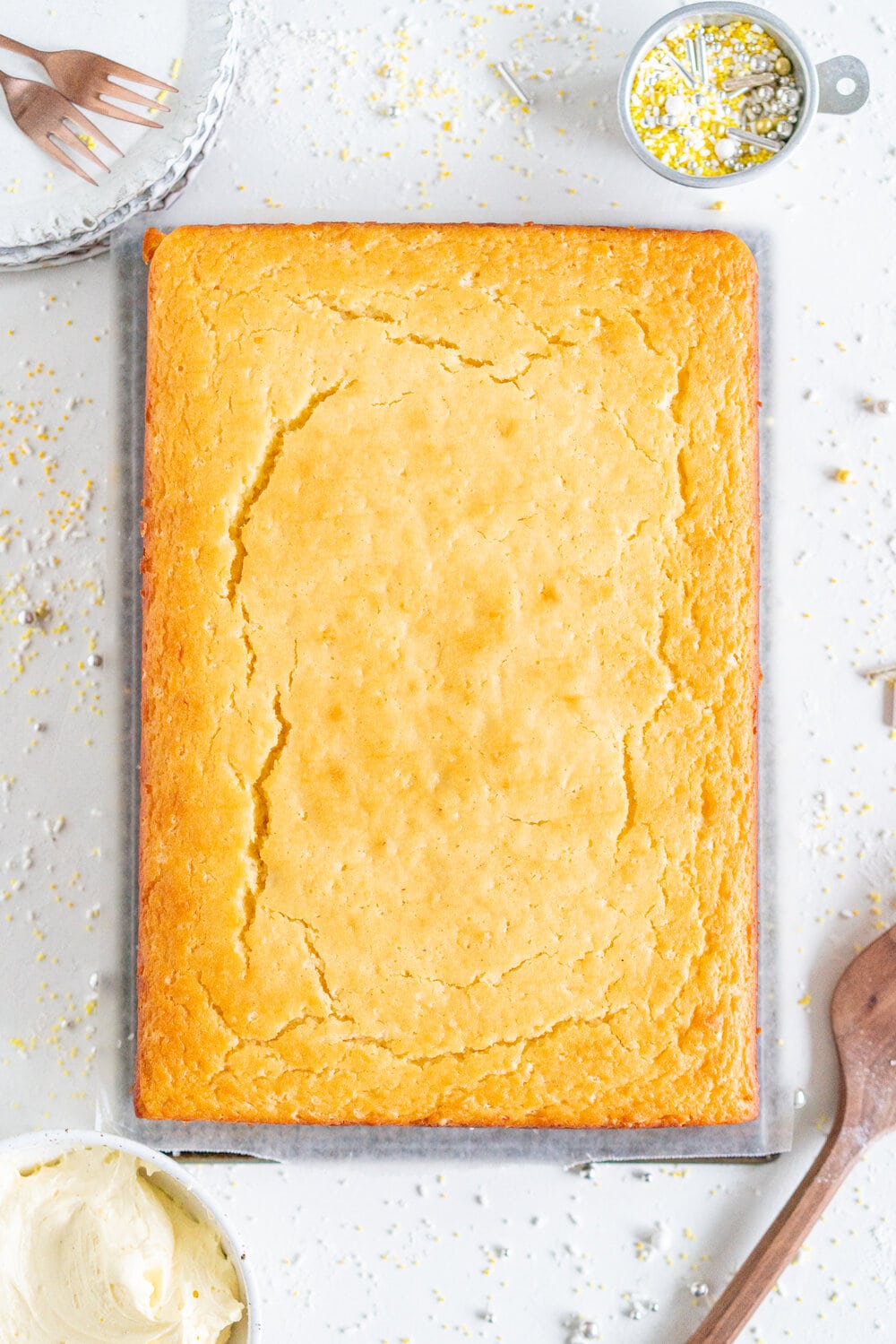 Lemon Yogurt Sheet Cake with Lemon Curd Swiss Meringue Buttercream. Fluffy lemon yogurt cake is topped with a punchy, silky lemon curd swiss meringue buttercream. This sheet cake is perfect for feeding a crowd. #sheetcake #lemoncurd #swissmeringuebuttercream