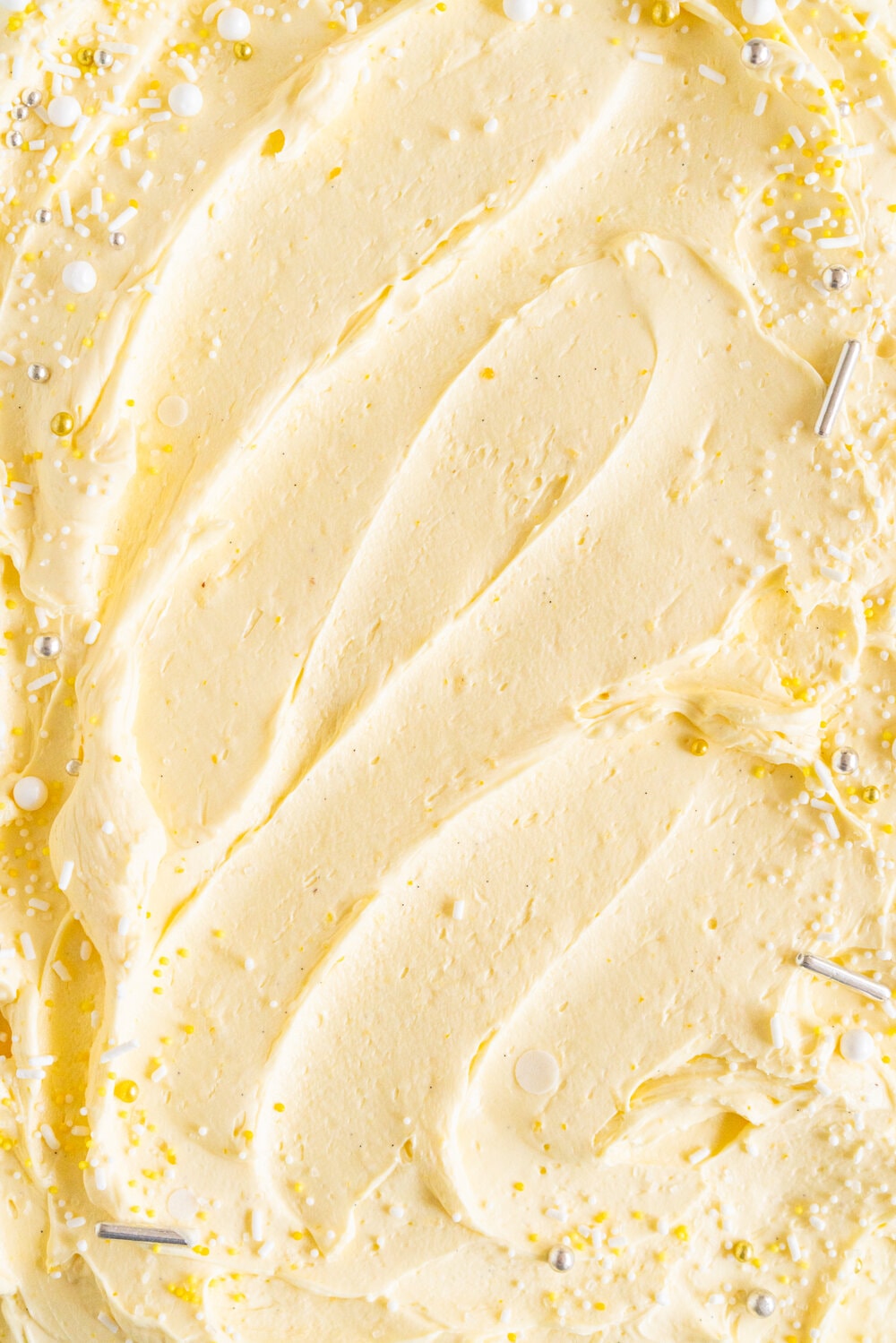 Lemon Yogurt Sheet Cake with Lemon Curd Swiss Meringue Buttercream. Fluffy lemon yogurt cake is topped with a punchy, silky lemon curd swiss meringue buttercream. This sheet cake is perfect for feeding a crowd. #sheetcake #lemoncurd #swissmeringuebuttercream