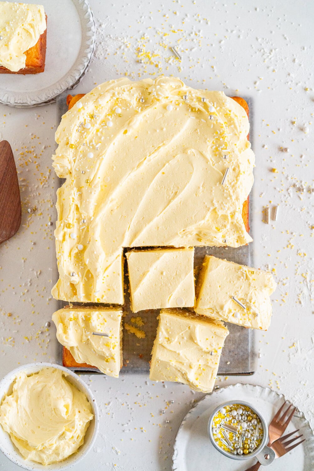 Lemon Yogurt Sheet Cake with Lemon Curd Swiss Meringue Buttercream. Fluffy lemon yogurt cake is topped with a punchy, silky lemon curd swiss meringue buttercream. This sheet cake is perfect for feeding a crowd. #sheetcake #lemoncurd #swissmeringuebuttercream