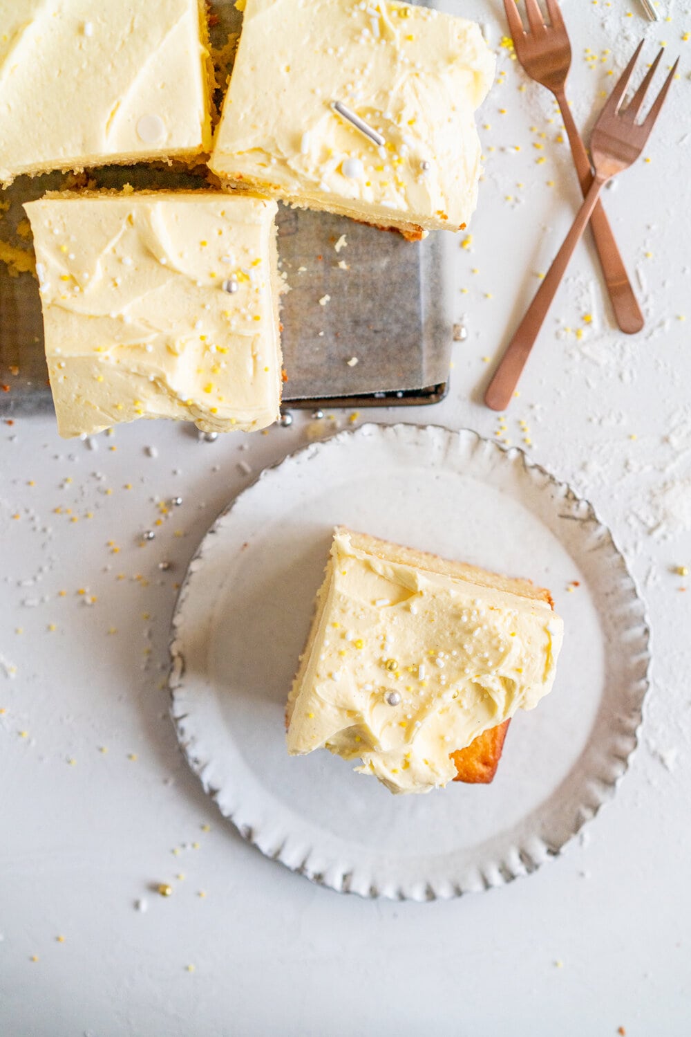 Lemon Yogurt Sheet Cake with Lemon Curd Swiss Meringue Buttercream. Fluffy lemon yogurt cake is topped with a punchy, silky lemon curd swiss meringue buttercream. This sheet cake is perfect for feeding a crowd. #sheetcake #lemoncurd #swissmeringuebuttercream
