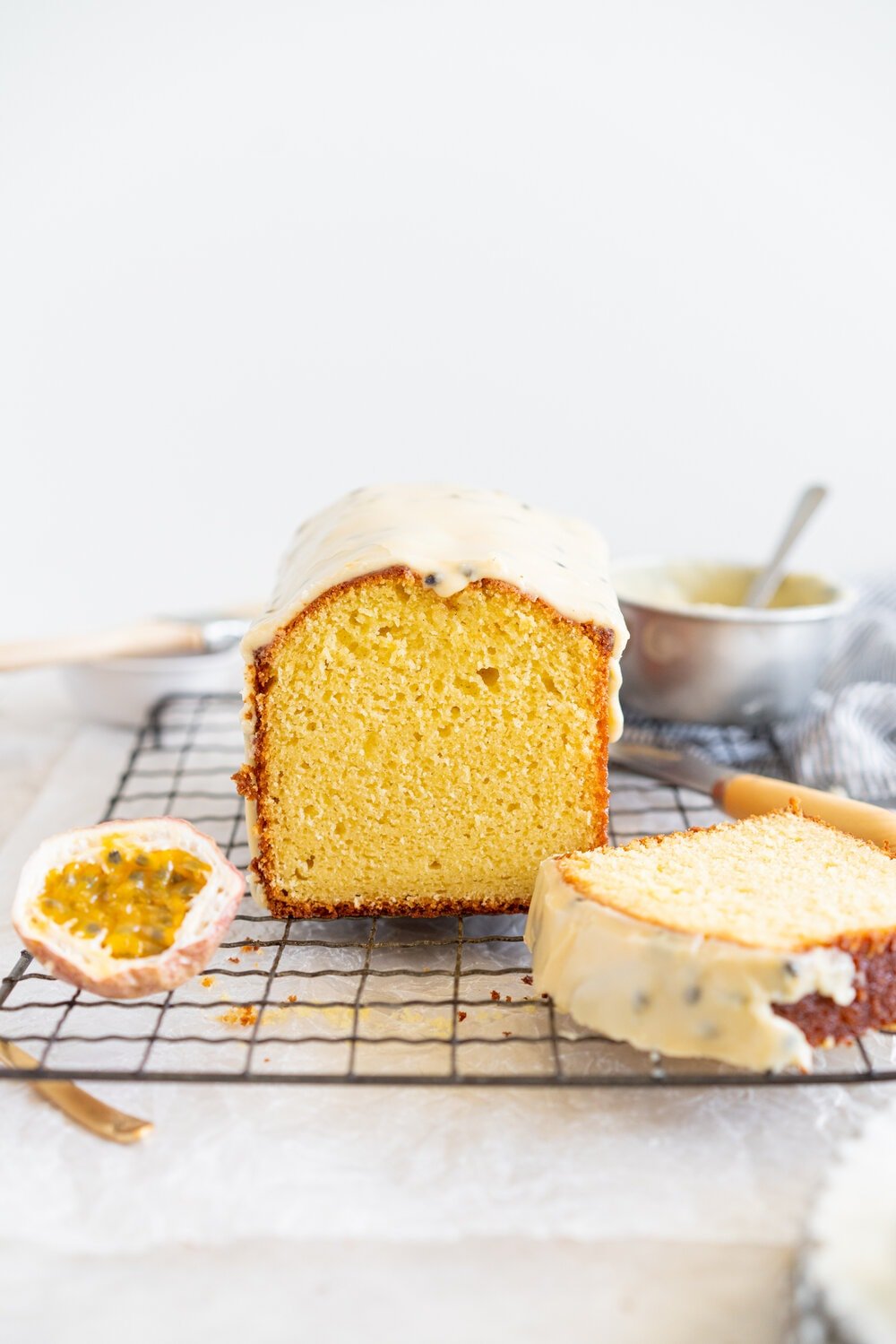 Olive Oil Passionfruit Loaf Cake. This passionfruit loaf cake has floral olive oil and a perfect texture from greek yogurt, and is brushed with a passionfruit syrup and finished with a passionfruit icing #passionfruit #loafcake #passionfruitloafcake