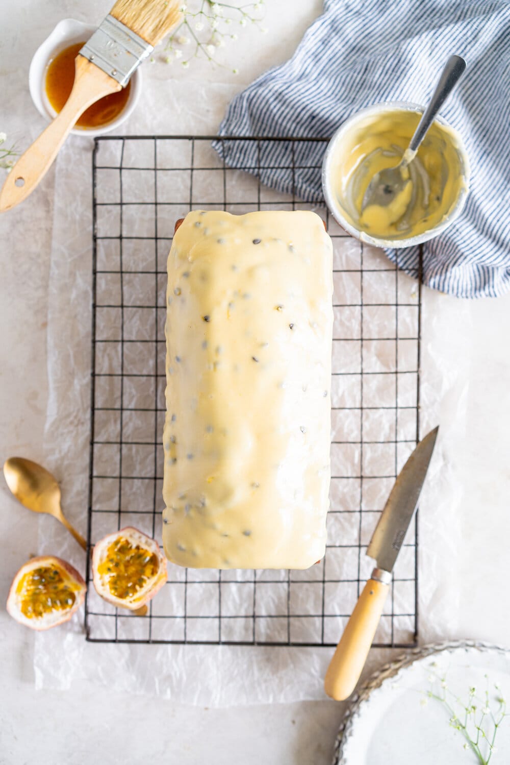 Olive Oil Passionfruit Loaf Cake. This passionfruit loaf cake has floral olive oil and a perfect texture from greek yogurt, and is brushed with a passionfruit syrup and finished with a passionfruit icing #passionfruit #loafcake #passionfruitloafcake
