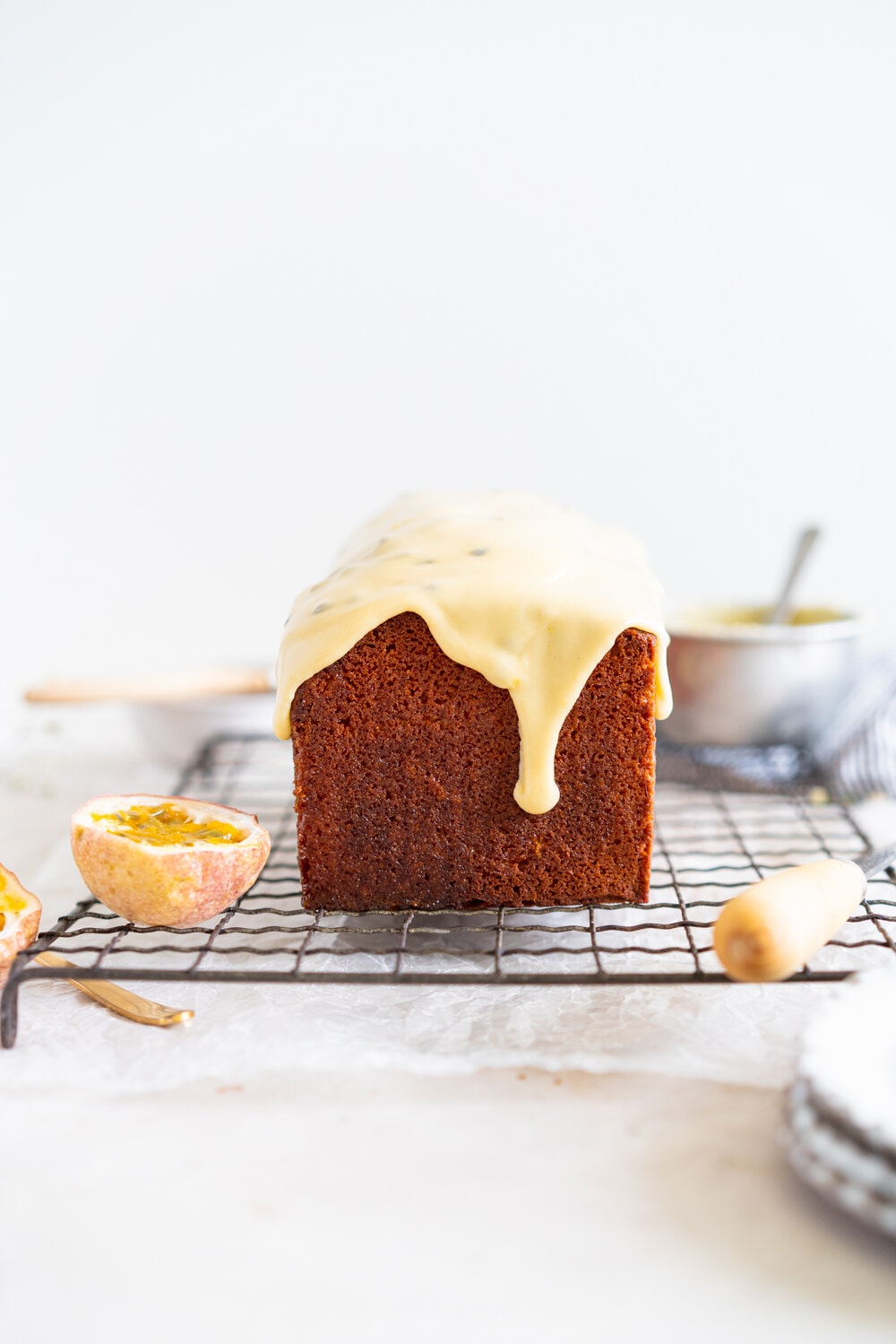 Olive Oil Passionfruit Loaf Cake. This passionfruit loaf cake has floral olive oil and a perfect texture from greek yogurt, and is brushed with a passionfruit syrup and finished with a passionfruit icing #passionfruit #loafcake #passionfruitloafcake