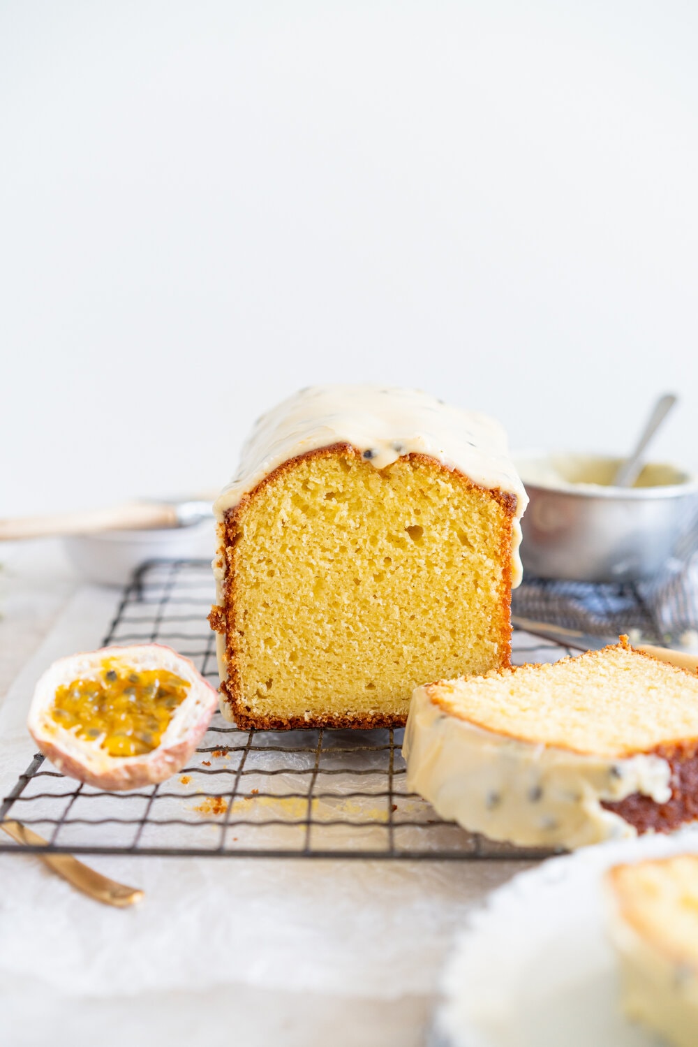 Olive Oil Passionfruit Loaf Cake. This passionfruit loaf cake has floral olive oil and a perfect texture from greek yogurt, and is brushed with a passionfruit syrup and finished with a passionfruit icing #passionfruit #loafcake #passionfruitloafcake