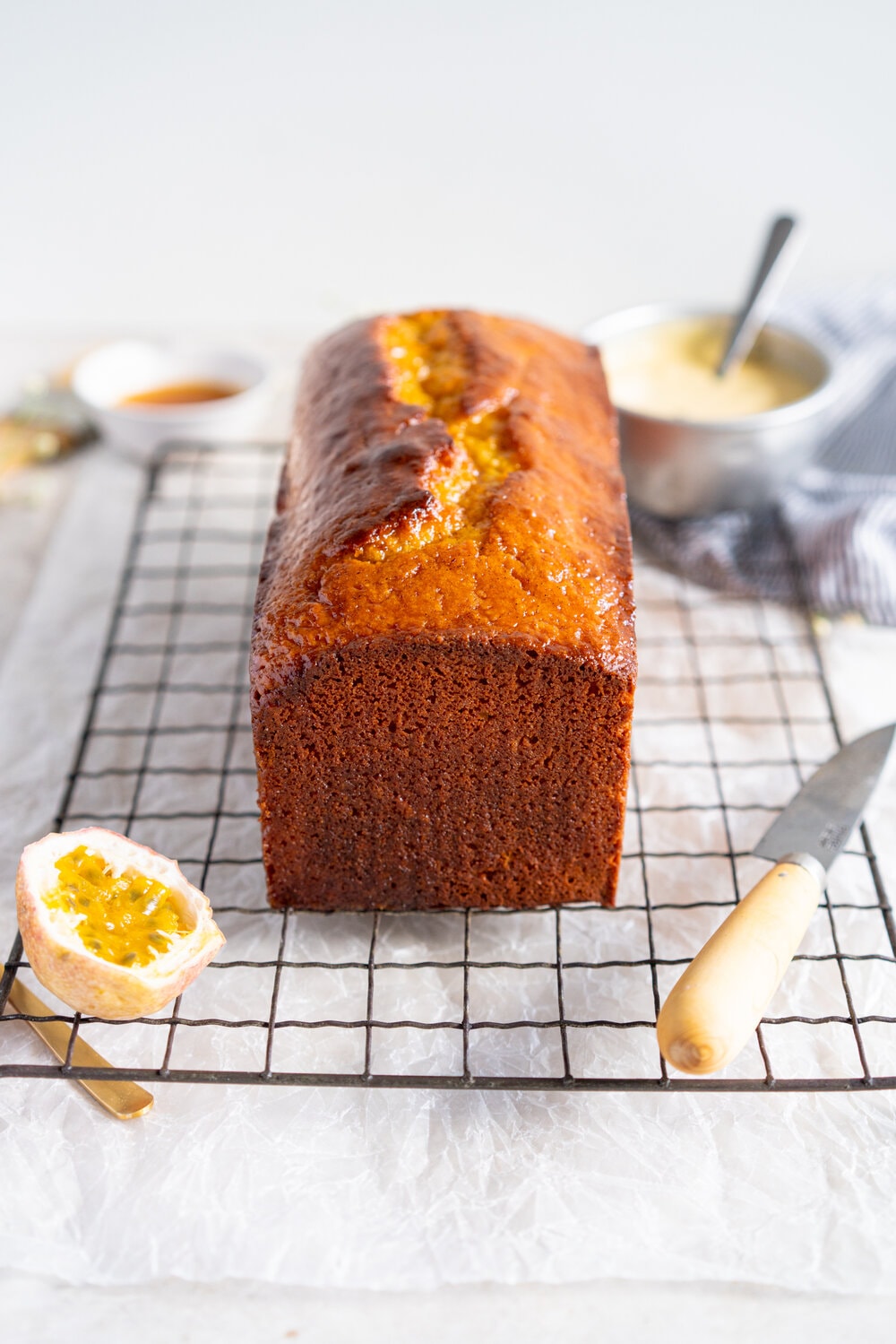 Olive Oil Passionfruit Loaf Cake. This passionfruit loaf cake has floral olive oil and a perfect texture from greek yogurt, and is brushed with a passionfruit syrup and finished with a passionfruit icing #passionfruit #loafcake #passionfruitloafcake