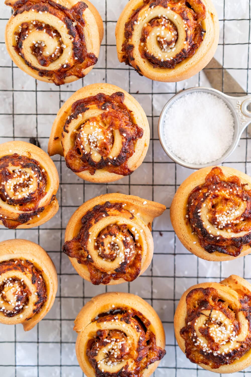 Sharp Cheddar cheese and caramelised onion brioche rolls. Fluffy brioche is spread with sweet caramelised onions and sprinkled with grated sharp cheddar, then rolled into perfect rolls and baked to perfection - cheesy onion goodness. These are easy to make and make the perfect savoury breakfast or brunch treat.