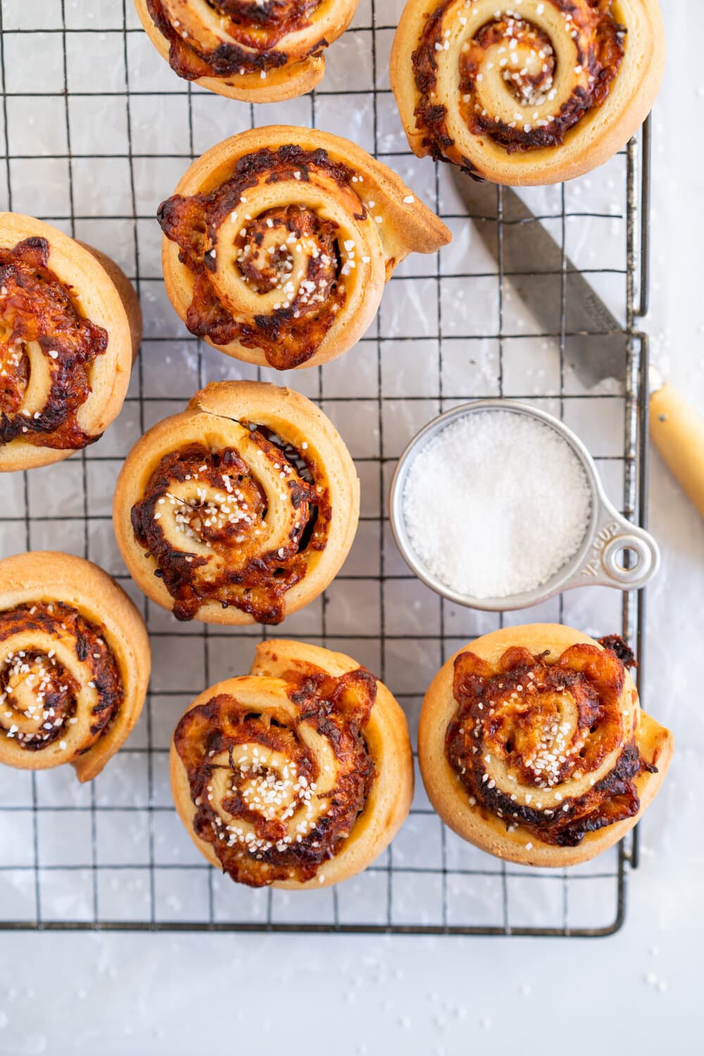 Sharp Cheddar cheese and caramelised onion brioche rolls. Fluffy brioche is spread with sweet caramelised onions and sprinkled with grated sharp cheddar, then rolled into perfect rolls and baked to perfection - cheesy onion goodness. These are easy to make and make the perfect savoury breakfast or brunch treat.