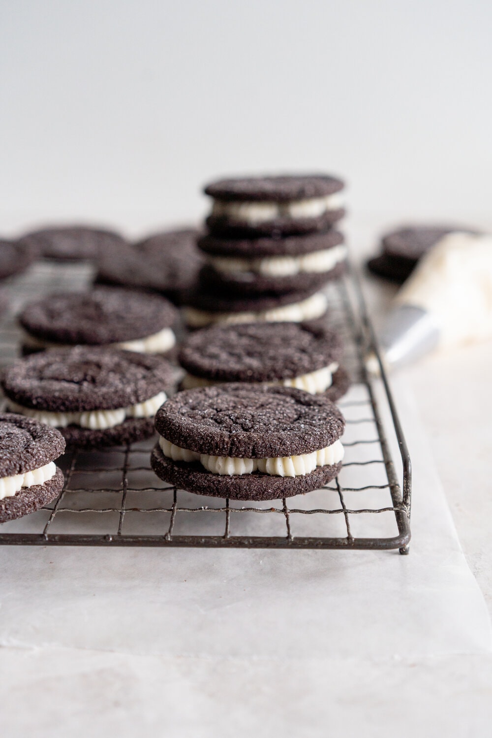 Black Cocoa Sugar Cookie Sandwiches with Cream Cheese Buttercream are the perfect 'grown-up oreo' treat! Soft, chewy black cocoa sugar cookies are paired with a smooth cream cheese frosting to make the perfect sugar cookie sandwich.