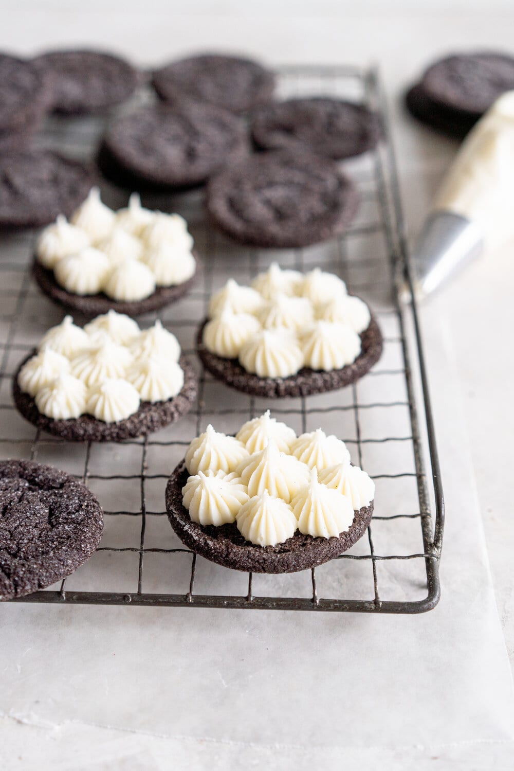 Black Cocoa Sugar Cookie Sandwiches with Cream Cheese Buttercream are the perfect 'grown-up oreo' treat! Soft, chewy black cocoa sugar cookies are paired with a smooth cream cheese frosting to make the perfect sugar cookie sandwich.