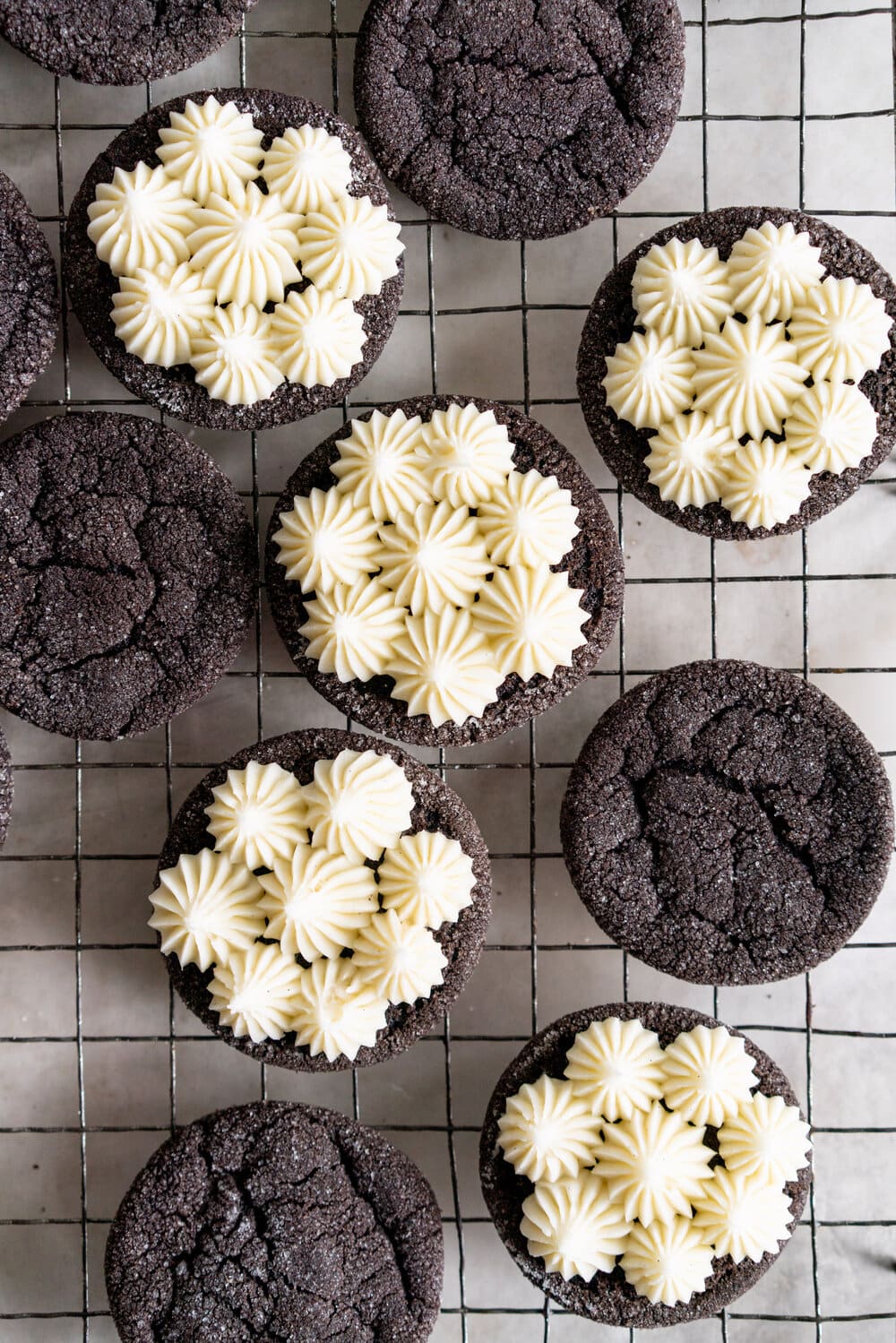 Black Cocoa Sugar Cookie Sandwiches with Cream Cheese Buttercream are the perfect 'grown-up oreo' treat! Soft, chewy black cocoa sugar cookies are paired with a smooth cream cheese frosting to make the perfect sugar cookie sandwich.