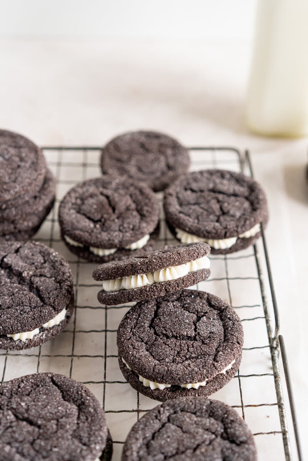Black Cocoa Sugar Cookie Sandwiches with Cream Cheese Buttercream are the perfect 'grown-up oreo' treat! Soft, chewy black cocoa sugar cookies are paired with a smooth cream cheese frosting to make the perfect sugar cookie sandwich.