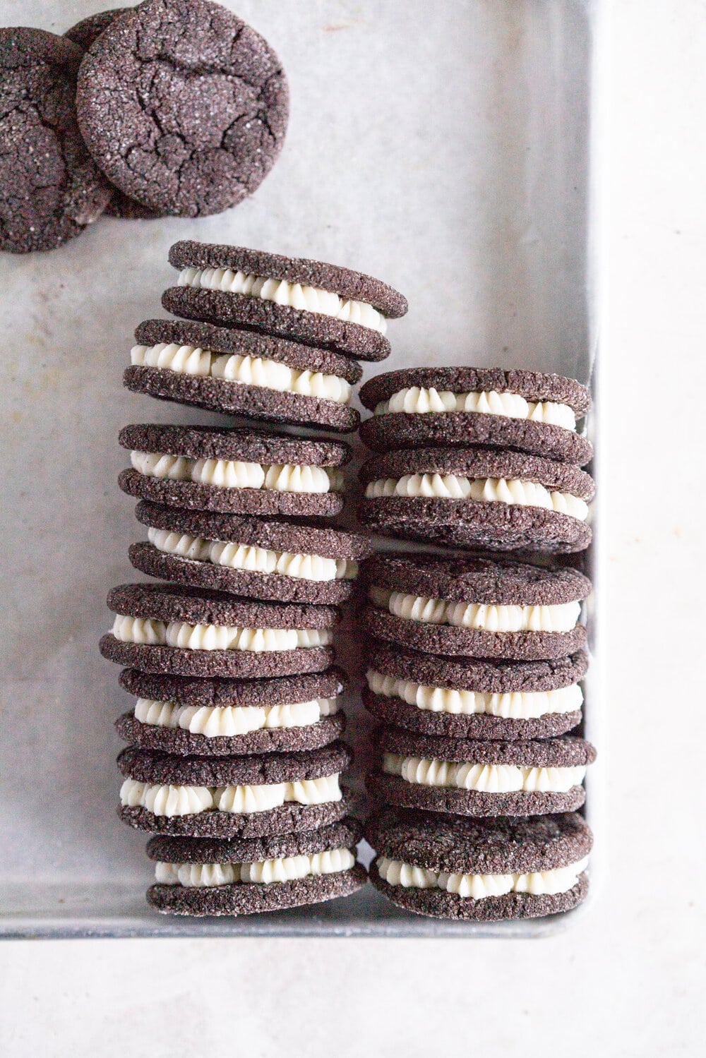 Black Cocoa Sugar Cookie Sandwiches with Cream Cheese Buttercream are the perfect 'grown-up oreo' treat! Soft, chewy black cocoa sugar cookies are paired with a smooth cream cheese frosting to make the perfect sugar cookie sandwich.