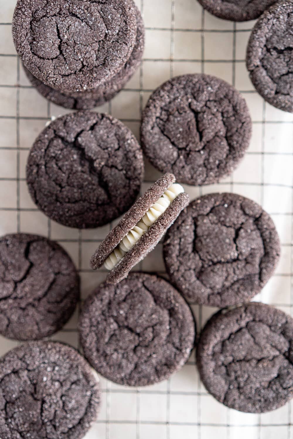 Black Cocoa Sugar Cookie Sandwiches with Cream Cheese Buttercream are the perfect 'grown-up oreo' treat! Soft, chewy black cocoa sugar cookies are paired with a smooth cream cheese frosting to make the perfect sugar cookie sandwich.
