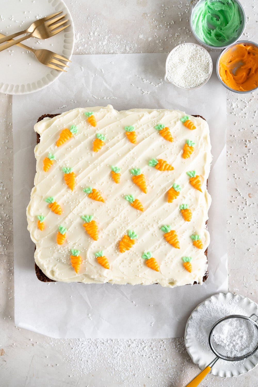 Carrot Snack Cake with Cream Cheese Frosting. This easy, moist, carrot sheet cake is the most perfect easter cake. It is made with pantry staples and finished with a simple cream cheese frosting and some super cute piped frosting carrots. This cake is great for a simple easter dessert, or for entertaining, as sheet cakes are super easy to transport.