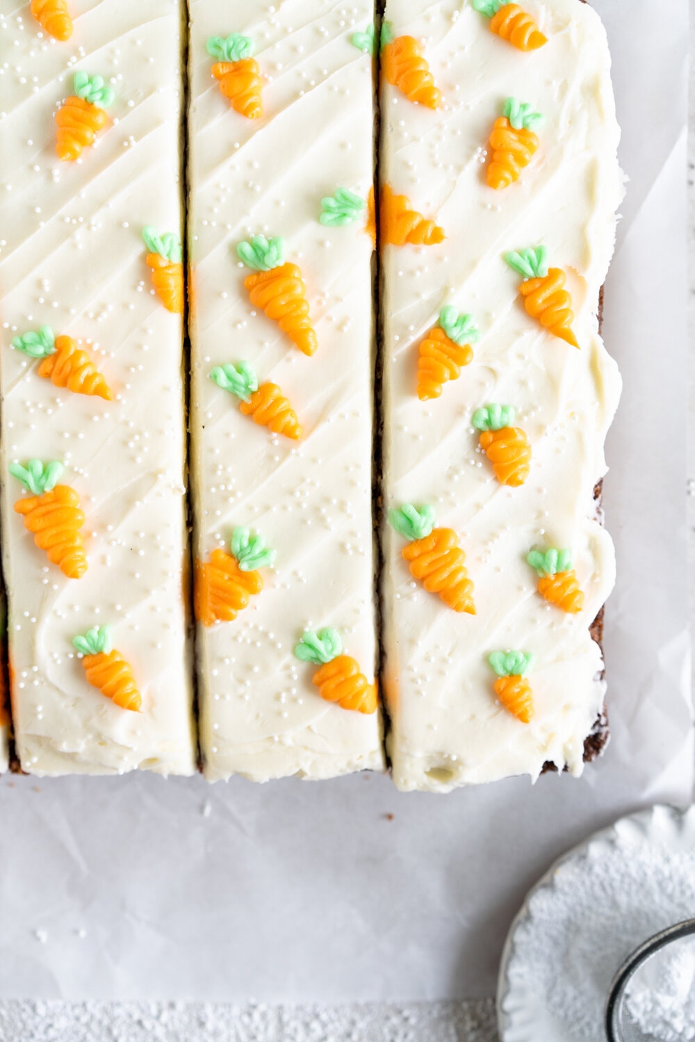 Carrot Snack Cake with Cream Cheese Frosting. This easy, moist, carrot sheet cake is the most perfect easter cake. It is made with pantry staples and finished with a simple cream cheese frosting and some super cute piped frosting carrots. This cake is great for a simple easter dessert, or for entertaining, as sheet cakes are super easy to transport.