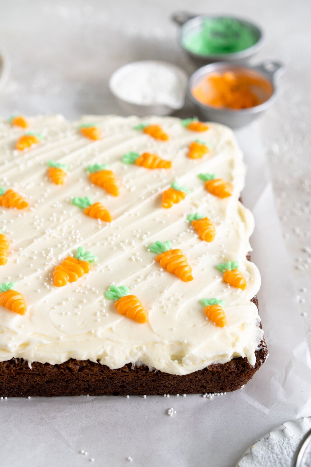 Carrot Snack Cake with Cream Cheese Frosting. This easy, moist, carrot sheet cake is the most perfect easter cake. It is made with pantry staples and finished with a simple cream cheese frosting and some super cute piped frosting carrots. This cake is great for a simple easter dessert, or for entertaining, as sheet cakes are super easy to transport.