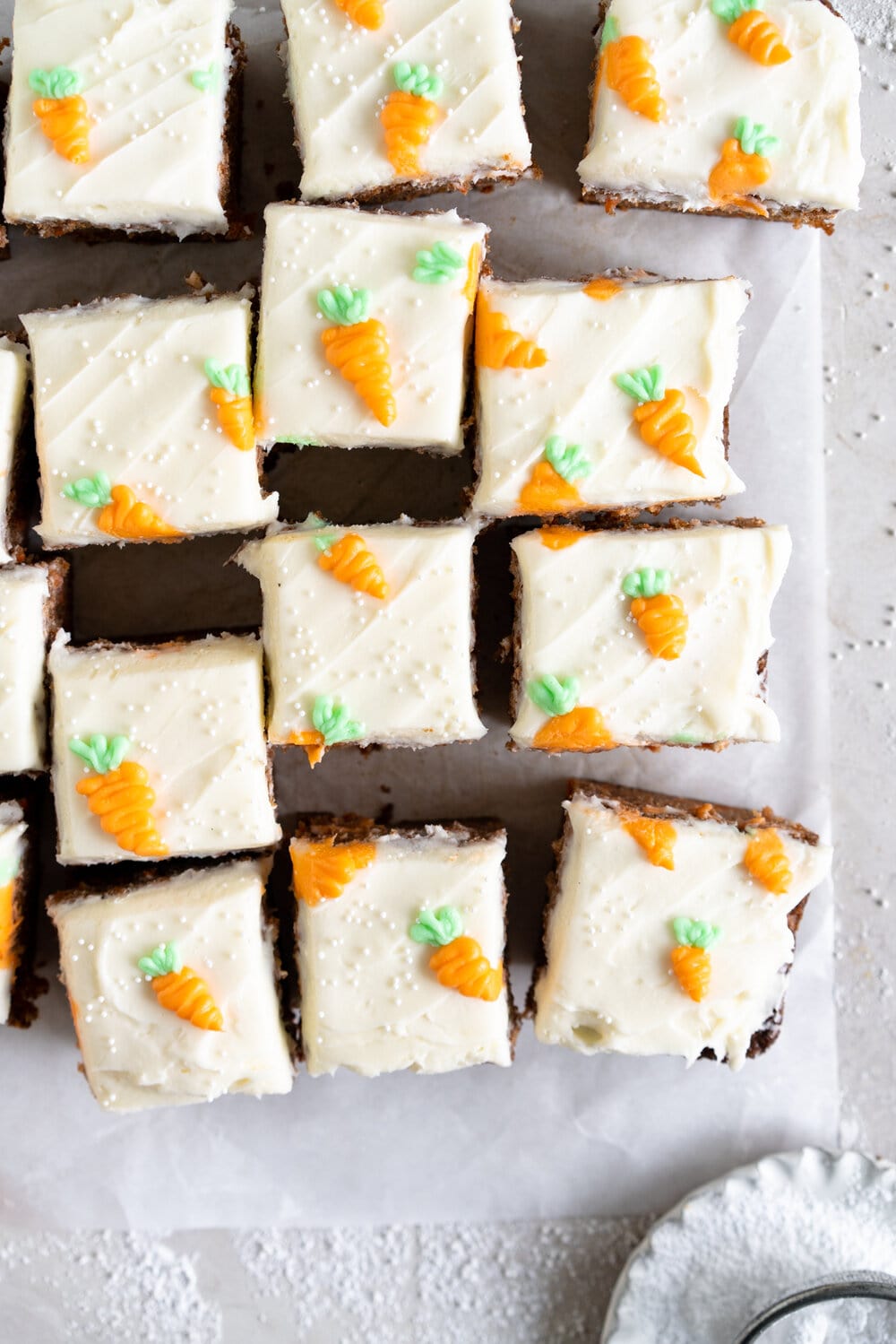 Carrot Snack Cake with Cream Cheese Frosting. This easy, moist, carrot sheet cake is the most perfect easter cake. It is made with pantry staples and finished with a simple cream cheese frosting and some super cute piped frosting carrots. This cake is great for a simple easter dessert, or for entertaining, as sheet cakes are super easy to transport.