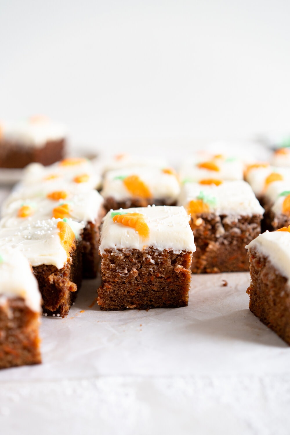 Carrot Snack Cake with Cream Cheese Frosting. This easy, moist, carrot sheet cake is the most perfect easter cake. It is made with pantry staples and finished with a simple cream cheese frosting and some super cute piped frosting carrots. This cake is great for a simple easter dessert, or for entertaining, as sheet cakes are super easy to transport.